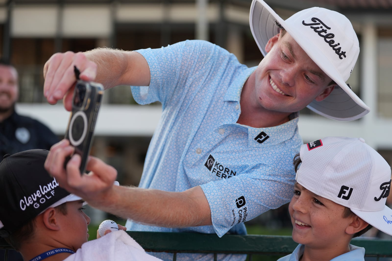 Joe Highsmith takes a selfie for a young fan after winning in the final round of the Cognizant Classic golf tournament, Sunday, March 2, 2025, in Palm Beach Gardens, Fla. (AP Photo/Rebecca Blackwell)