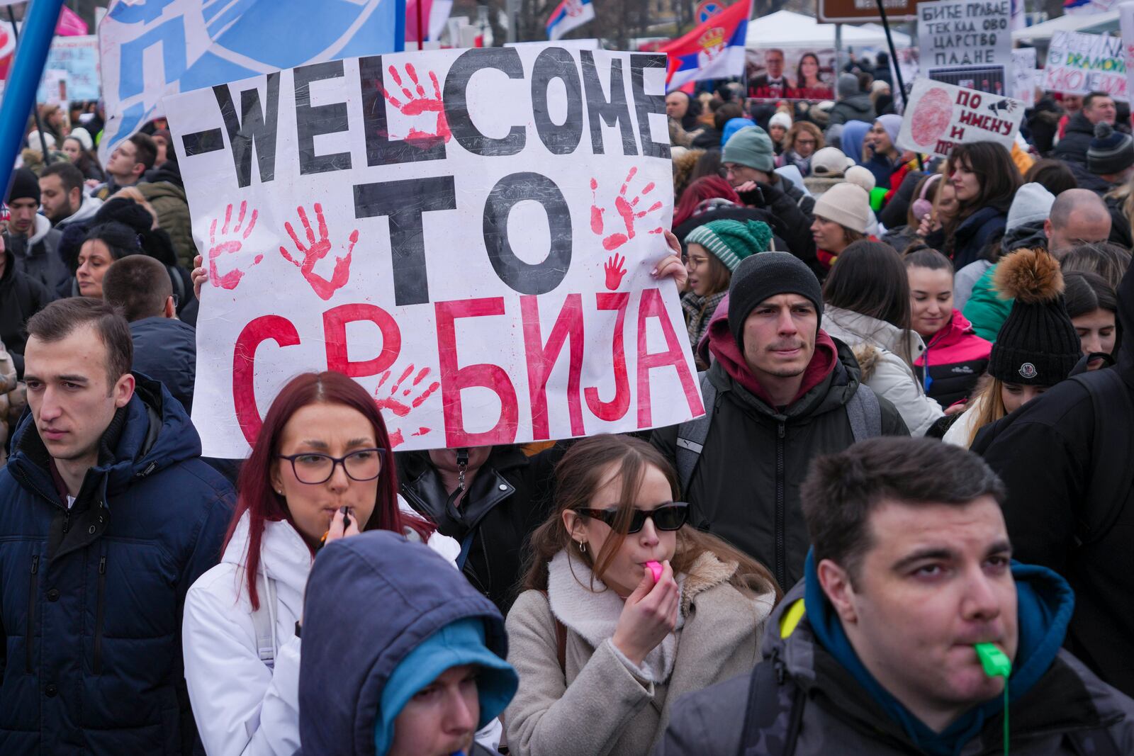 People hold banner that reads: "Welcome to Serbia" during a protest triggered after a concrete canopy on a railway station in the northern city of Novi Sad collapsed on Nov. 1, 2024 killed 15 people, in Kragujevac, Serbia, Saturday, Feb. 15, 2025. (AP Photo/Darko Vojinovic)