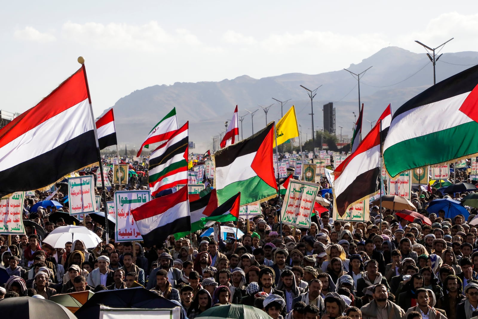 Houthi supporters wave Palestinian and Yemeni flags during an anti-Israel rally in Sanaa, Yemen, Friday, Jan. 10, 2025. (AP Photo/Osamah Abdulrahman)