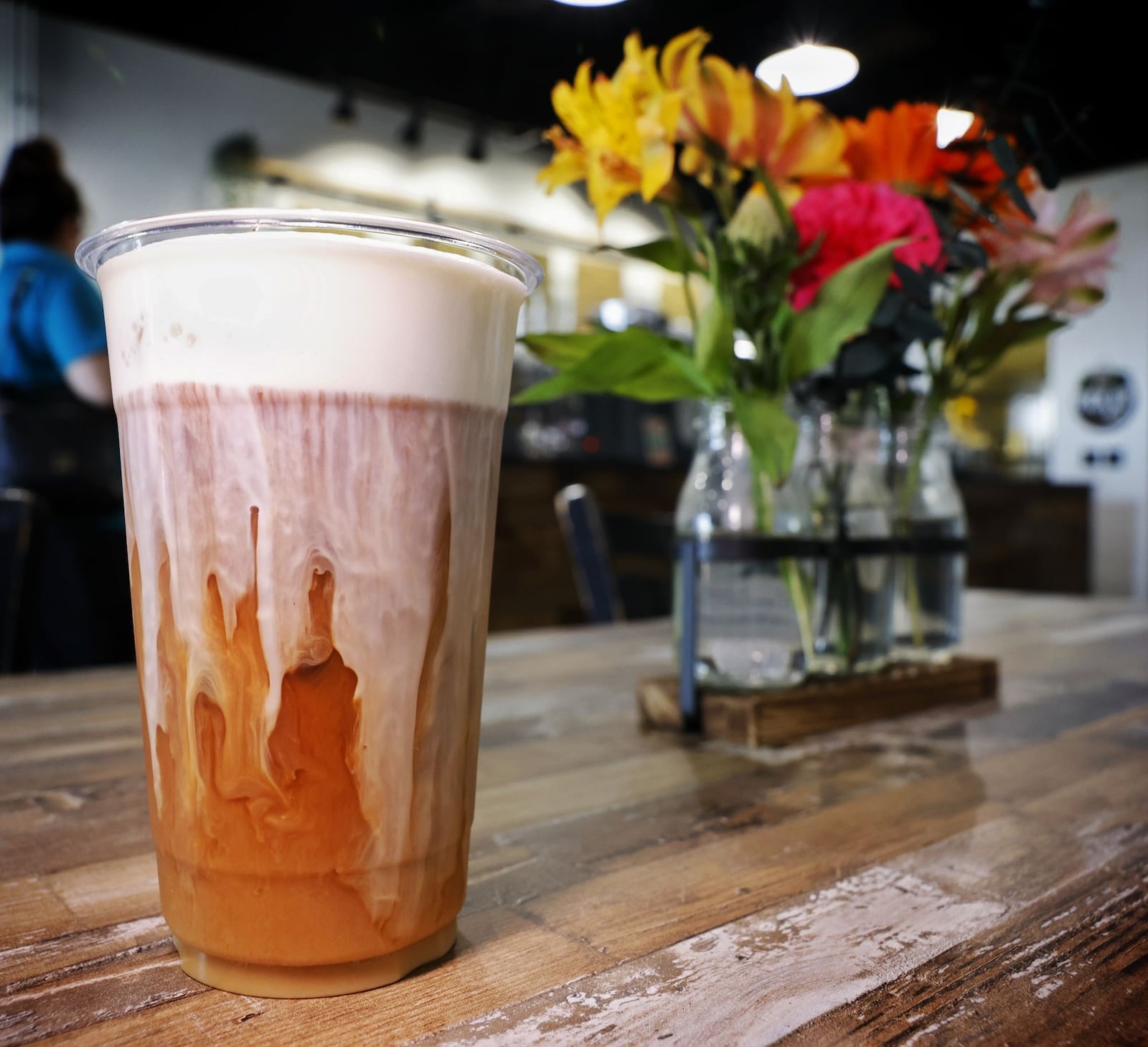 Sweet cream foam is poured over a cold brew coffee at State Street Coffee in Trenton. NICK GRAHAM/STAFF