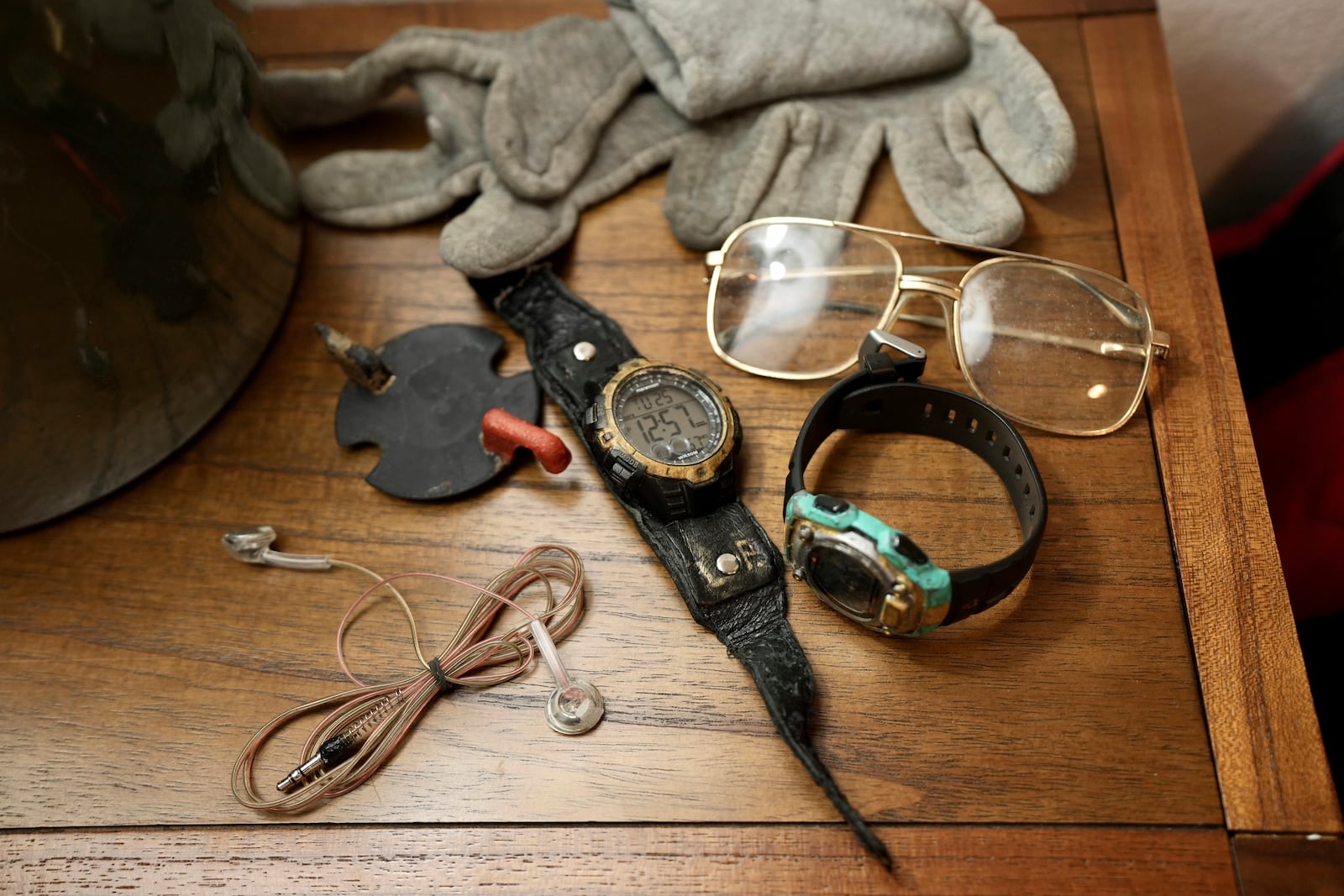 The eyeglasses and watches Leonard Peltier brought home from prison sit on his nightstand in Belcourt, N.D, on Tuesday, Feb. 25, 2025. (AP Photo/Mark Vancleave)