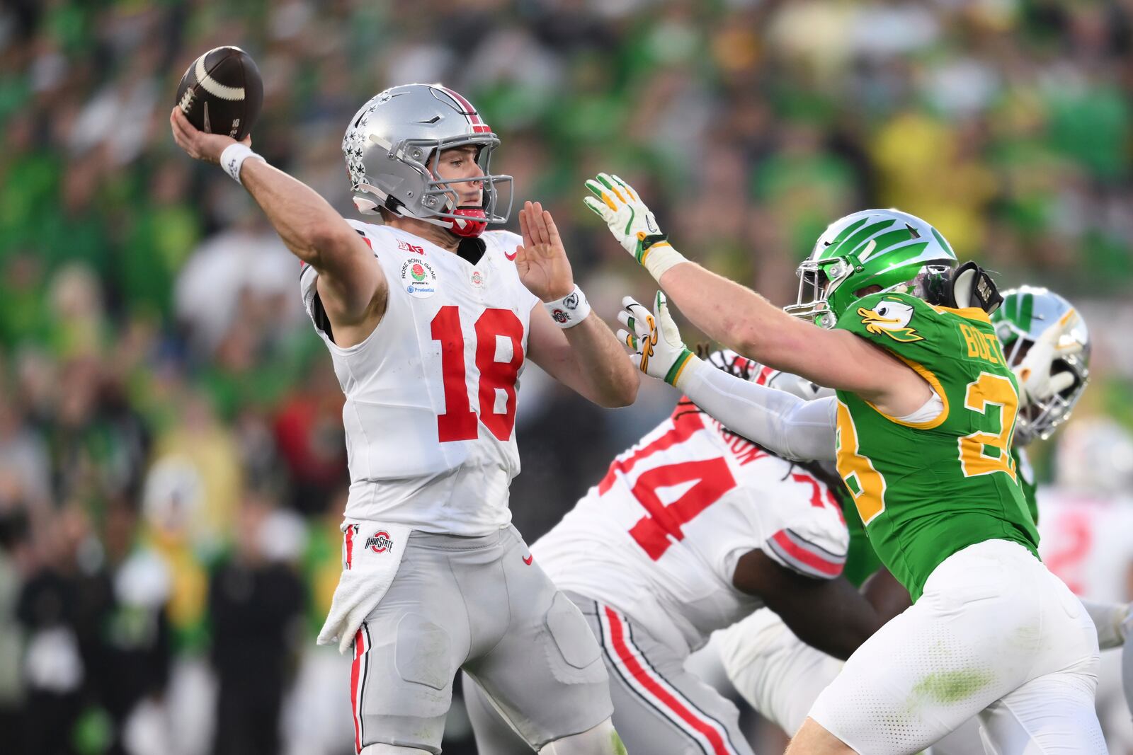 Ohio State quarterback Will Howard (18) throws a pass over Oregon linebacker Bryce Boettcher (28) during the second half in the quarterfinals of the Rose Bowl College Football Playoff, Wednesday, Jan. 1, 2025, in Pasadena, Calif. (AP Photo/Kyusung Gong)