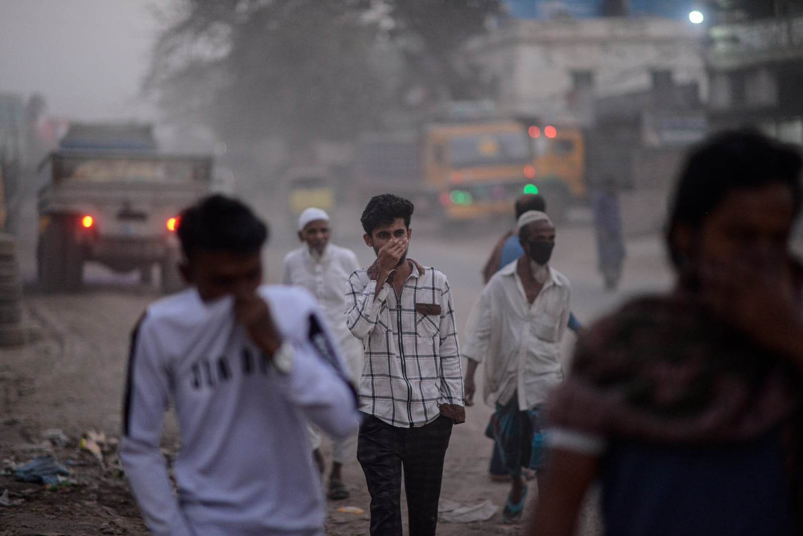 People cover their faces to protect themselves from the pollution, in Dhaka, Bangladesh, on Feb. 8, 2025. (AP Photo/Mahmud Hossain Opu)