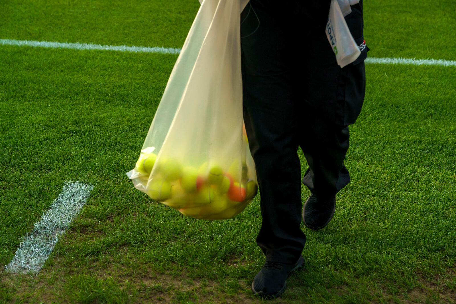 FILE - Pitch crews clean up after the home crowd threw tennis balls onto the pitch in a protest against VAR, shortly after kick-off in soccer match between Lillestrom and KFUM Oslo at Arasen Stadium in Oslo, June 27, 2024. (Cornelius Poppe/NTB via AP, file)