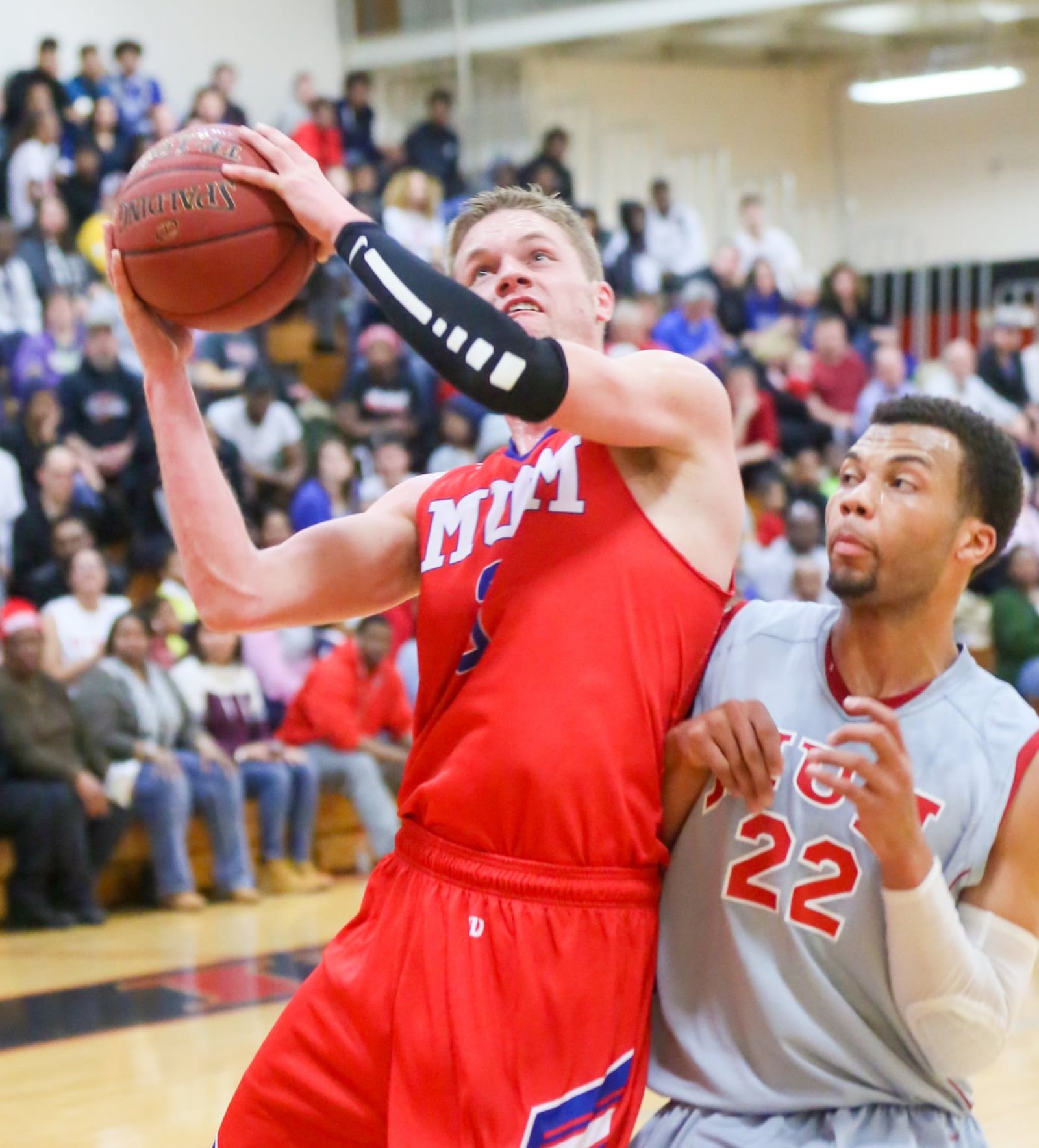 Miami Middletown forward Eli Staton (3) bumps into Miami Hamilton’s Chris Edwards (22) on Wednesday night at MUH. GREG LYNCH/STAFF