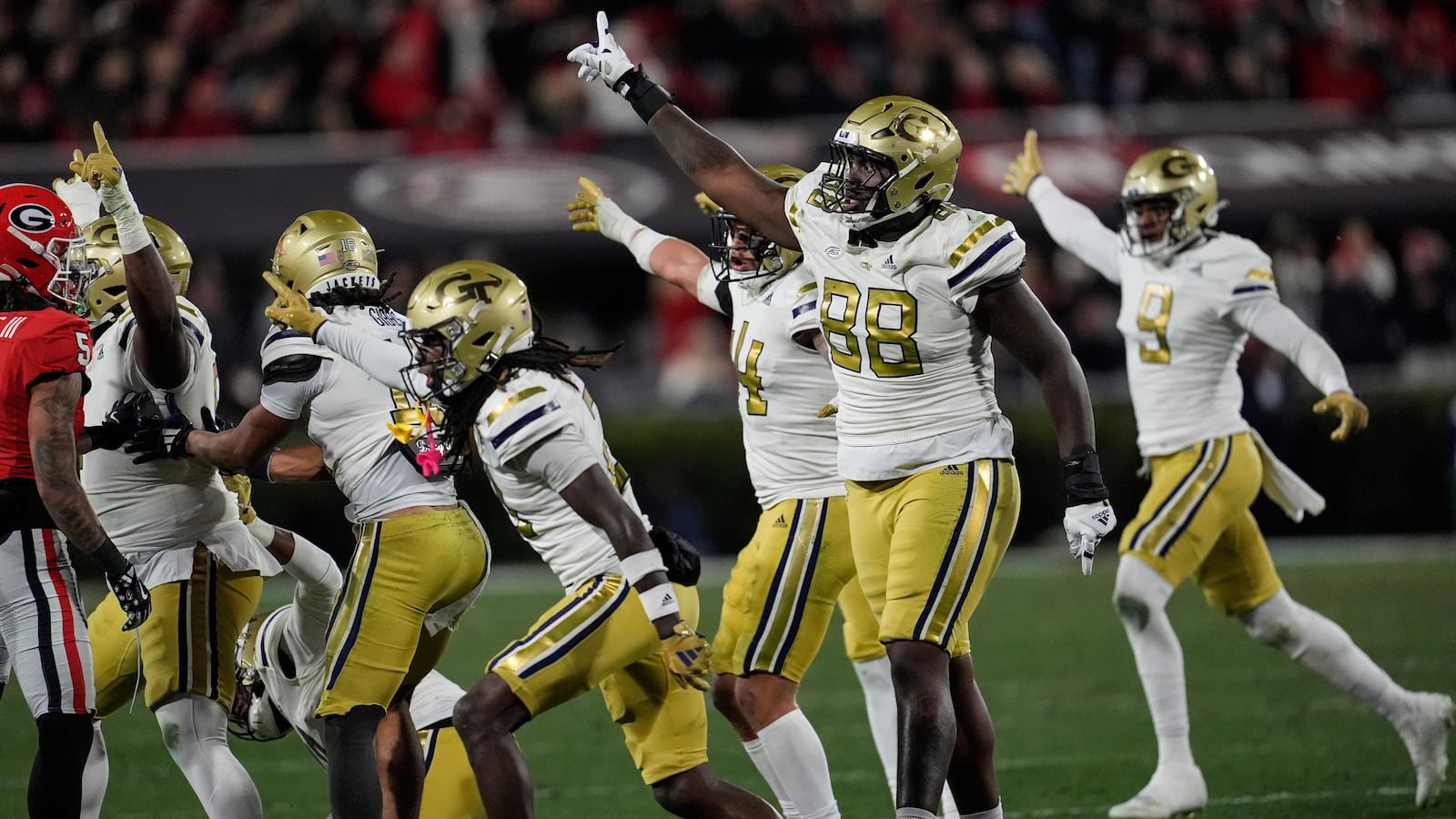 Georgia Tech defense celebrate a fumble by Georgia wide receiver Dominic Lovett (6) during the first half of an NCAA college football game, Friday, Nov. 29, 2024, in Athens, Ga. (AP Photo/Mike Stewart)