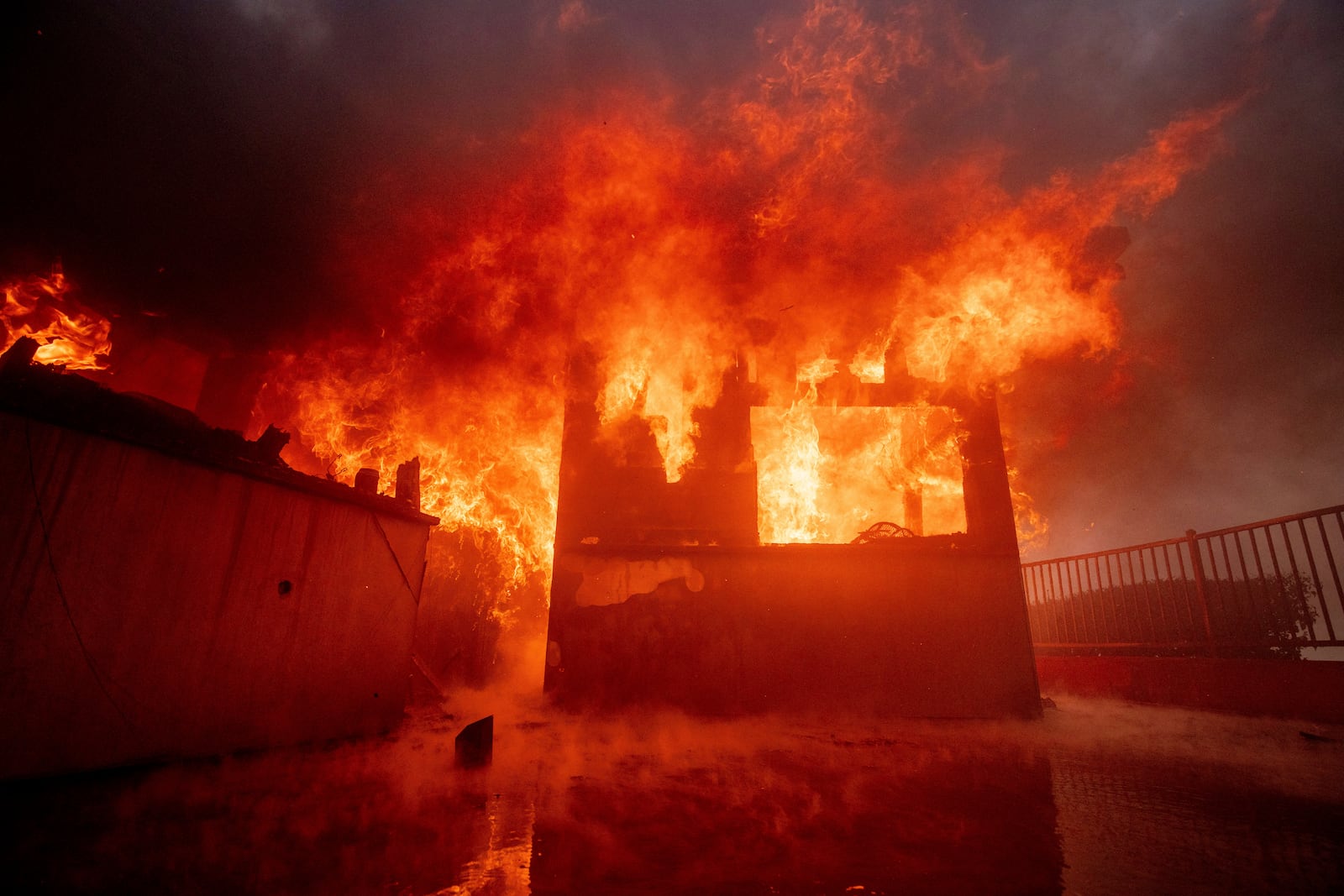 The Palisades Fire burns a property in the Pacific Palisades neighborhood of Los Angeles, Tuesday, Jan. 7, 2025. (AP Photo/Etienne Laurent)