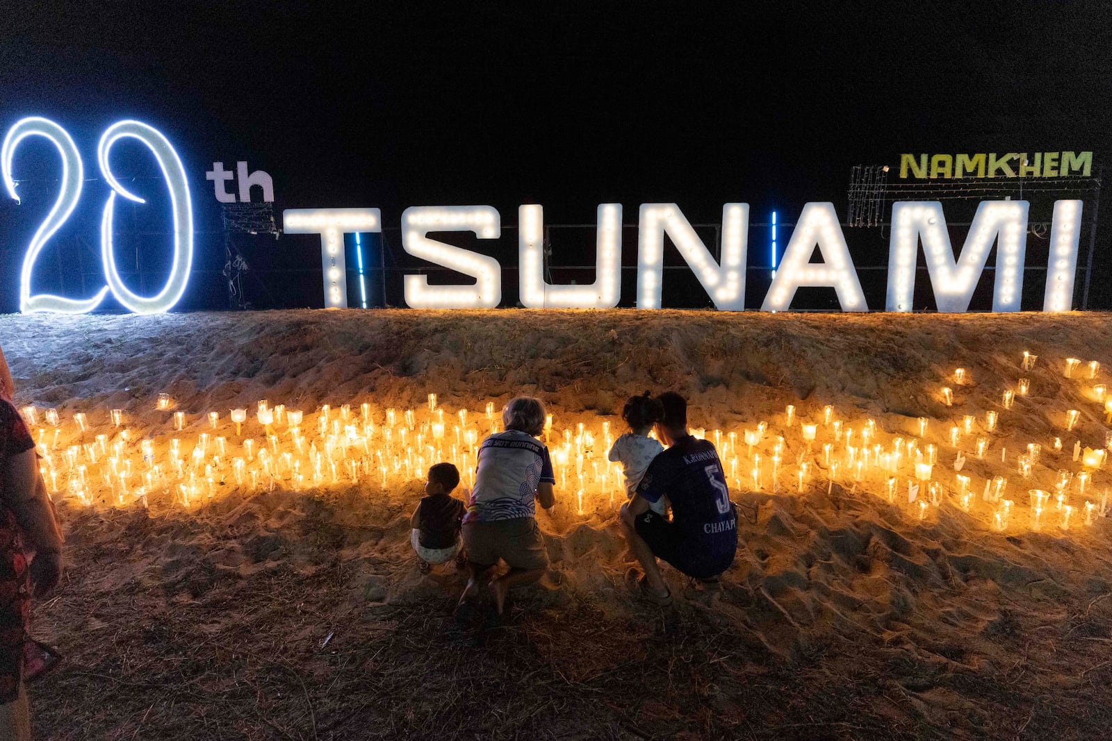 Relatives of victims of the 2004 Indian Ocean tsunami hold a candle light vigil as they participate in the 20th anniversary, at Tsunami Memorial Park at Ban Nam Khem, Takuapa district of Phang Nga province, southern Thailand, Thursday, Dec. 26, 2024. (AP Photo/Wason Wanichakorn)