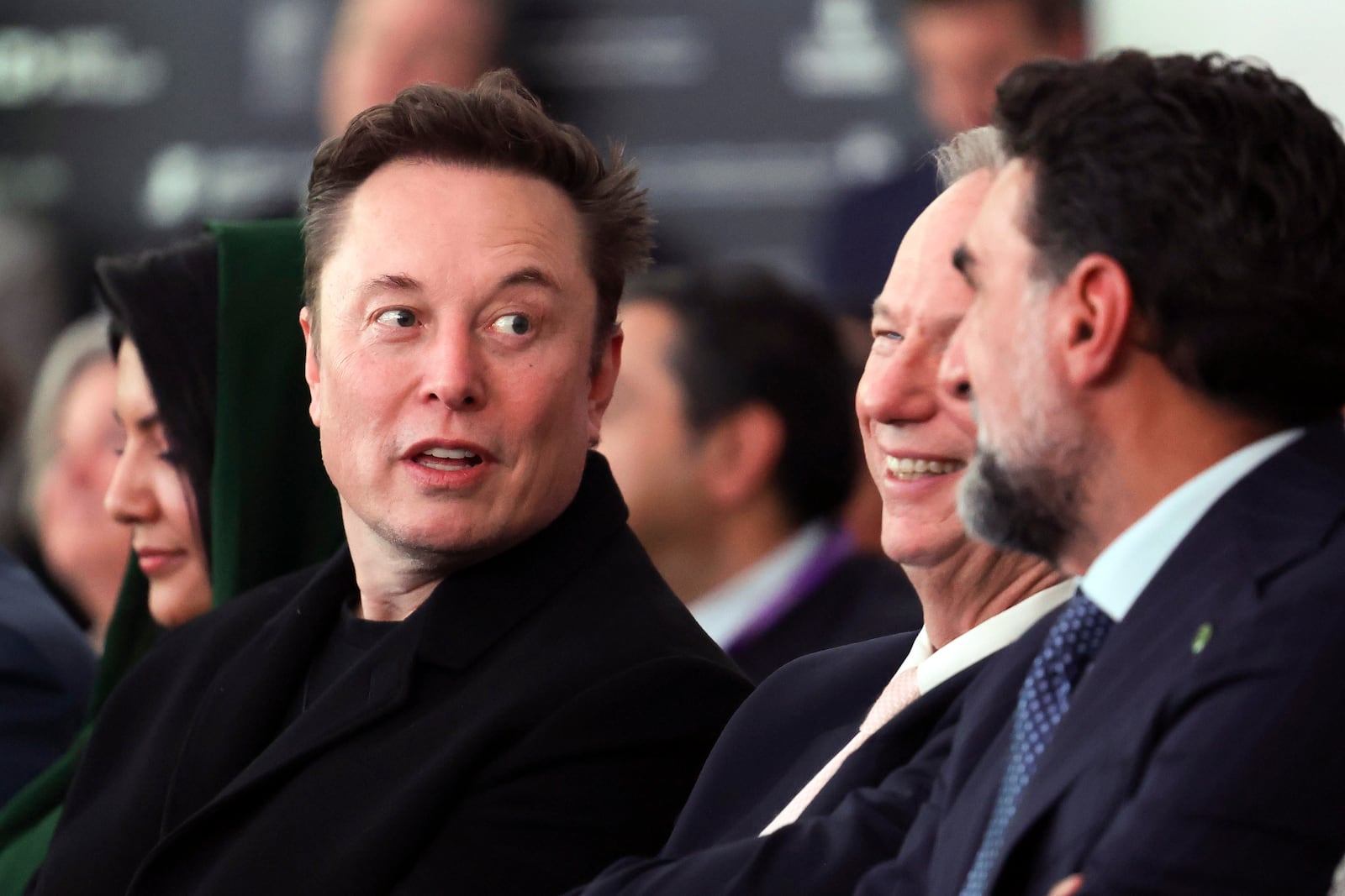 Elon Musk arrives before President Donald Trump speaks at the Future Investment Initiative (FII) Institute summit in Miami Beach, Fla., Wednesday, Feb. 19, 2025. (Pool via AP)