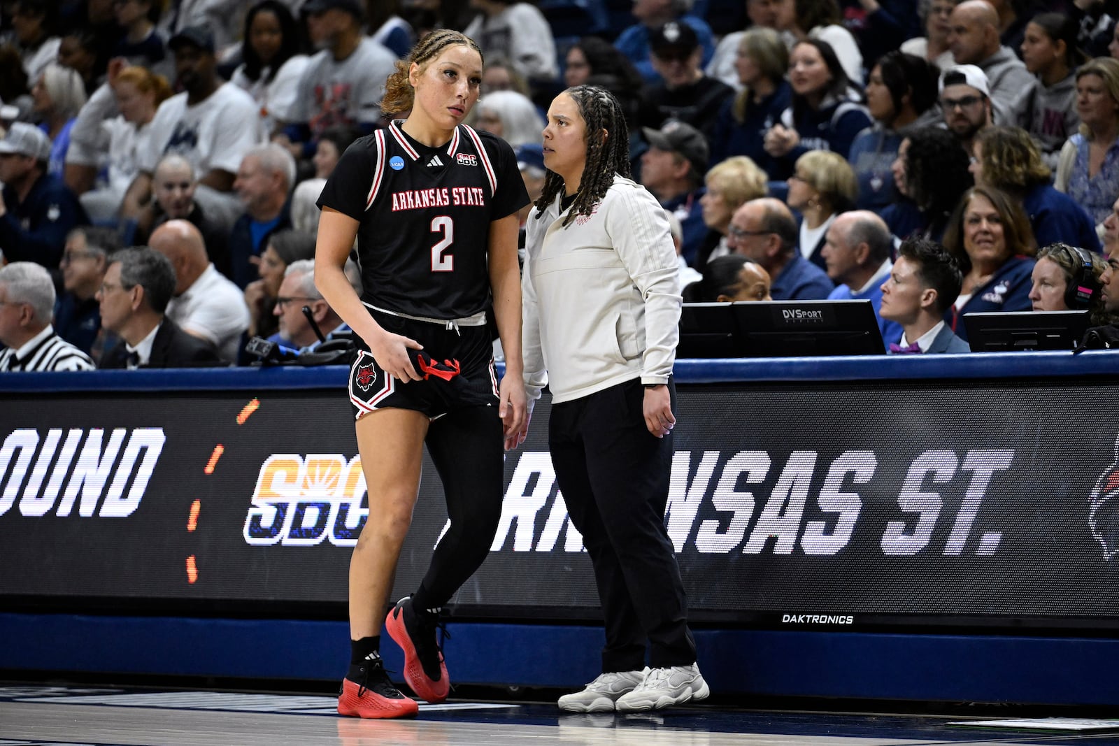 Arkansas State head coach Destinee Rogers, right, talks with Arkansas State guard Wynter Rogers (2) during the first half in the first round of the NCAA college basketball tournament, Saturday, March 22, 2025, in Storrs, Conn. (AP Photo/Jessica Hill)