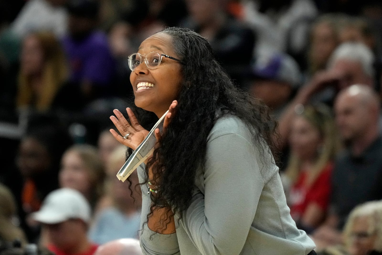 Seattle Storm head coach Noelle Quinn shouts instructions to her players during the first half of a WNBA basketball game against the Phoenix Mercury, Thursday, Sept. 19, 2024, in Phoenix. (AP Photo/Ross D. Franklin)