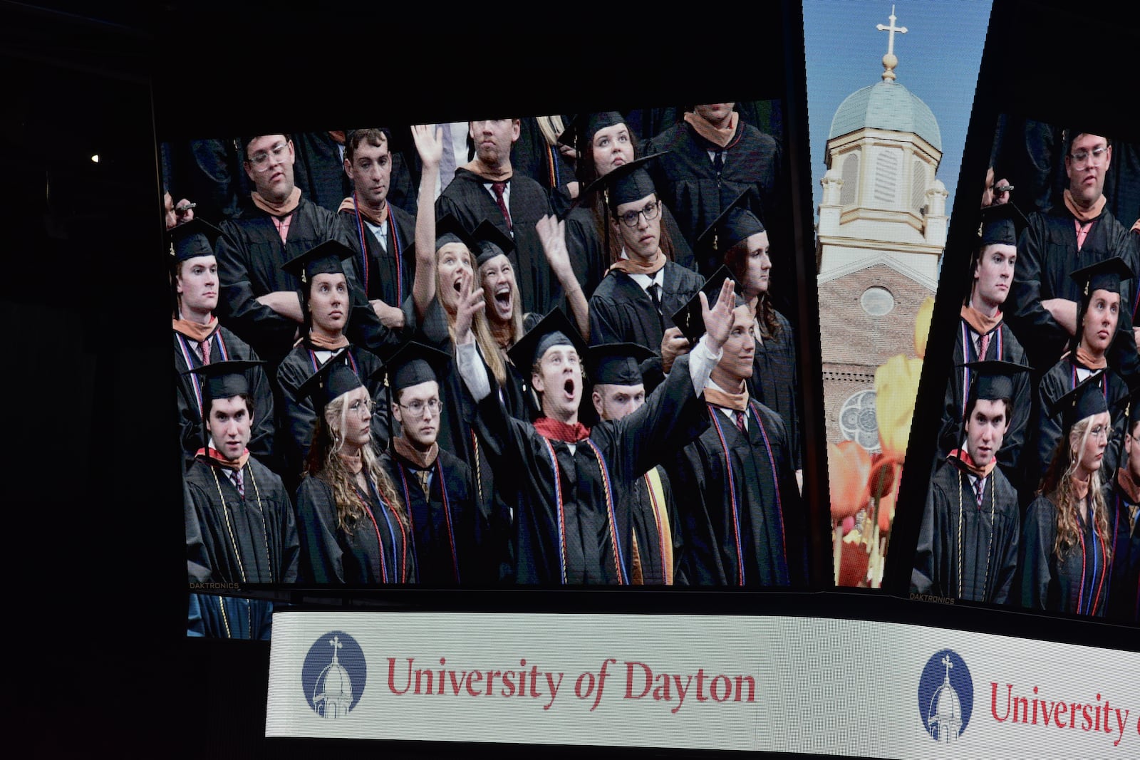 University of Dayton 2024 graduates celebrate during the undergraduate commencement on Sunday, May 5, 2024, on the jumbotron at UD Arena. SAM WILDOW\STAFF