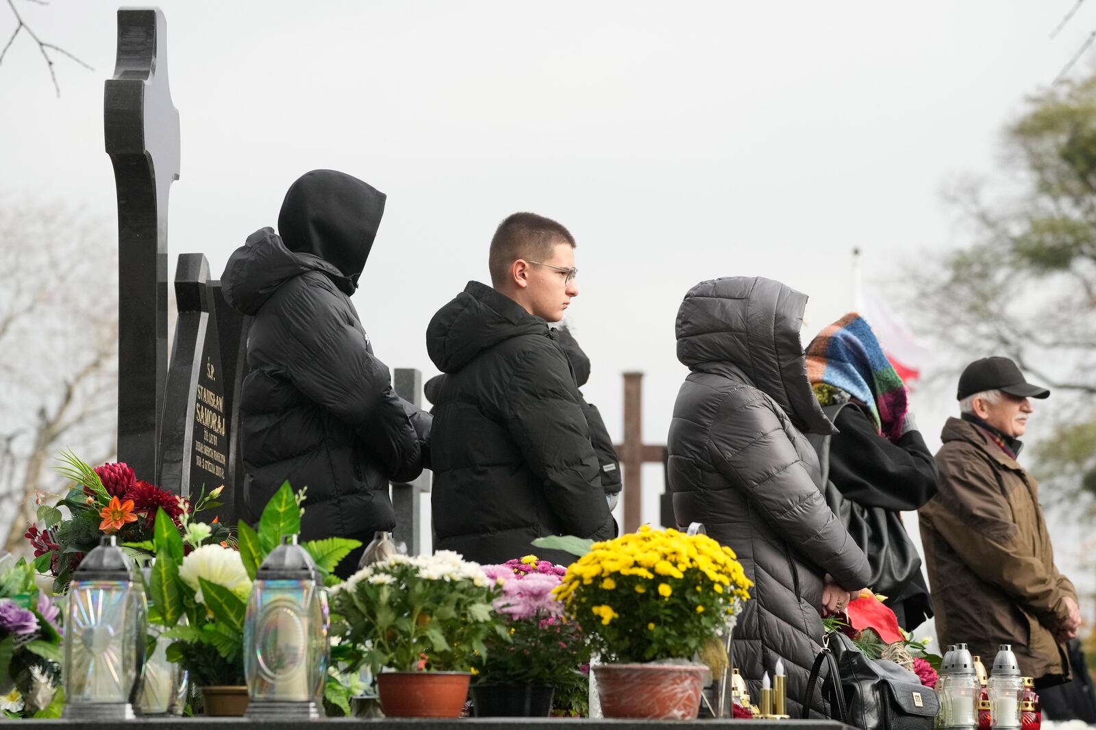 Candles burn on All Saints' Day, a time for reflecting on those who have died, on Friday Nov. 1, 2024, in Zakroczym near Warsaw, Poland. (AP Photo/Czarek Sokolowski)