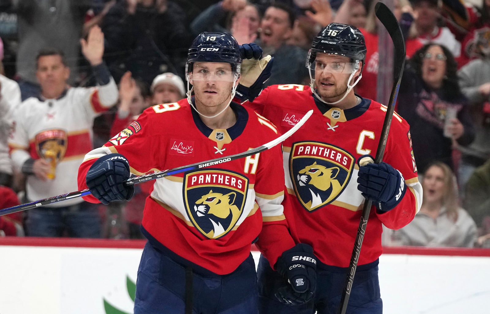 Florida Panthers left wing Matthew Tkachuk (19) celebrates with center Aleksander Barkov (16) after scoring a goal during the second period of an NHL hockey game against the Ottawa Senators Saturday, Feb. 8, 2025, in Sunrise, Fla. (AP Photo/Lynne Sladky)