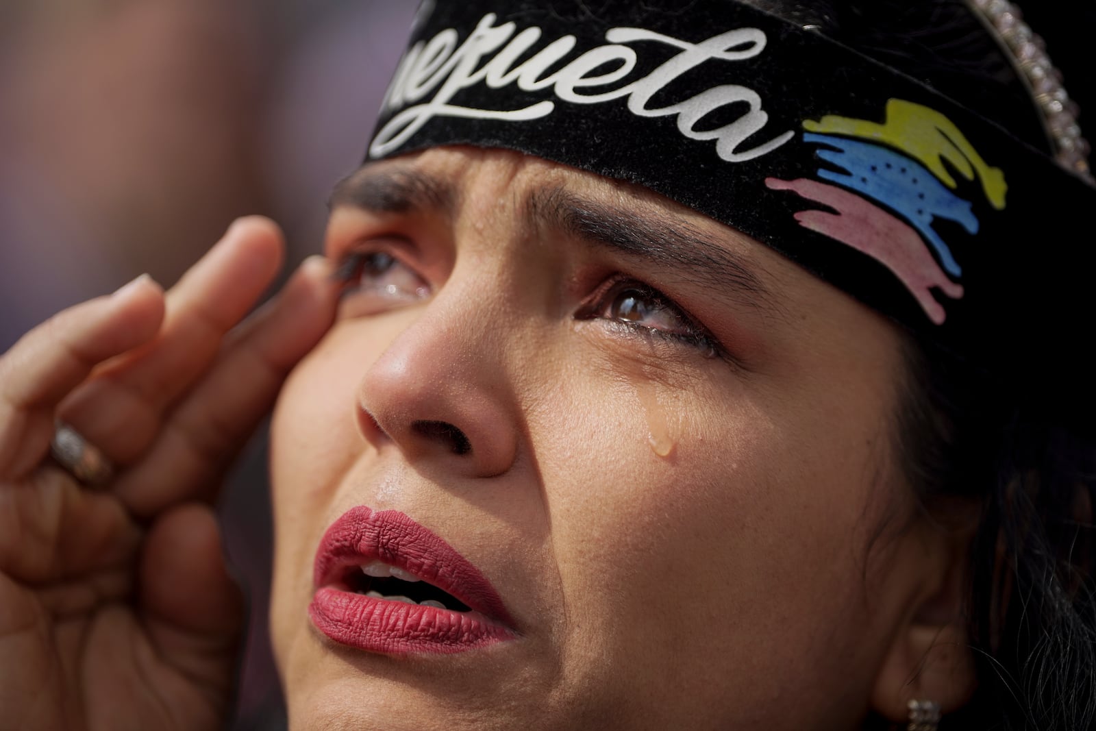 A woman cries during a protest by opponents of Venezuelan President Nicolas Maduro the day before his inauguration for a third term, in Bogota, Colombia, Thursday, Jan. 9, 2025. (AP Photo/Ivan Valencia)