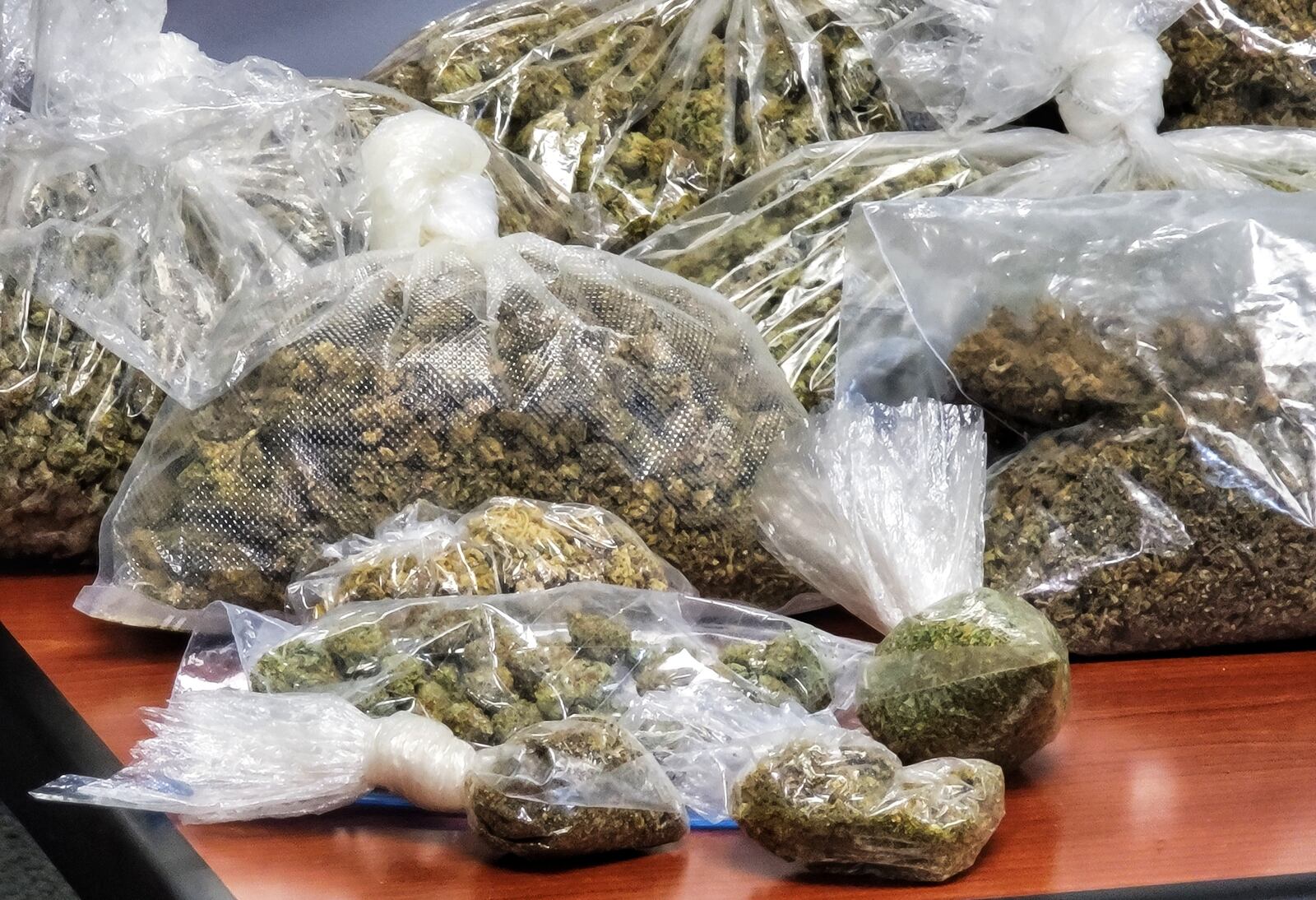 20 pounds of marijuan, two kilos of cocaine, guns and $75,000 in cash were seized from a Ridgelawn Avenue house in Hamilton Wednesday buy  the Butler County B.U.R.N. unit. NICK GRAHAM/STAFF