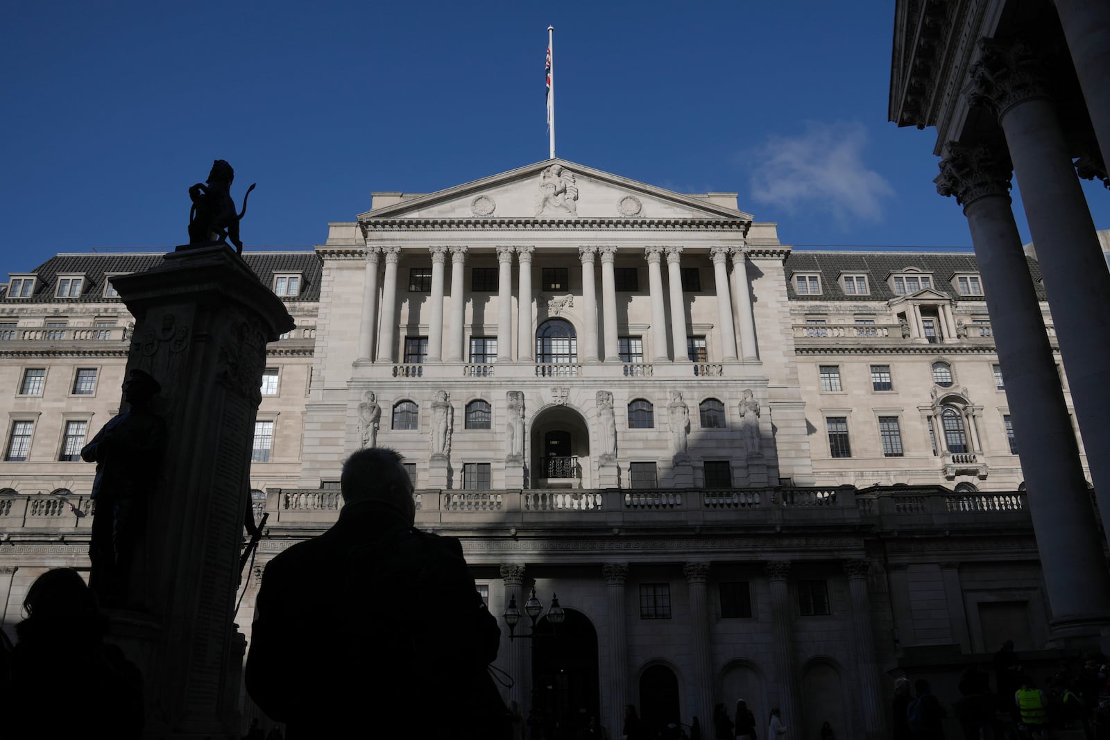 A man is silhouetted in front of the Bank of England in London, Thursday, Feb. 6, 2025 which is widely expected to cut interest rates for the third time in six months later Thursday. (AP Photo/Kin Cheung)