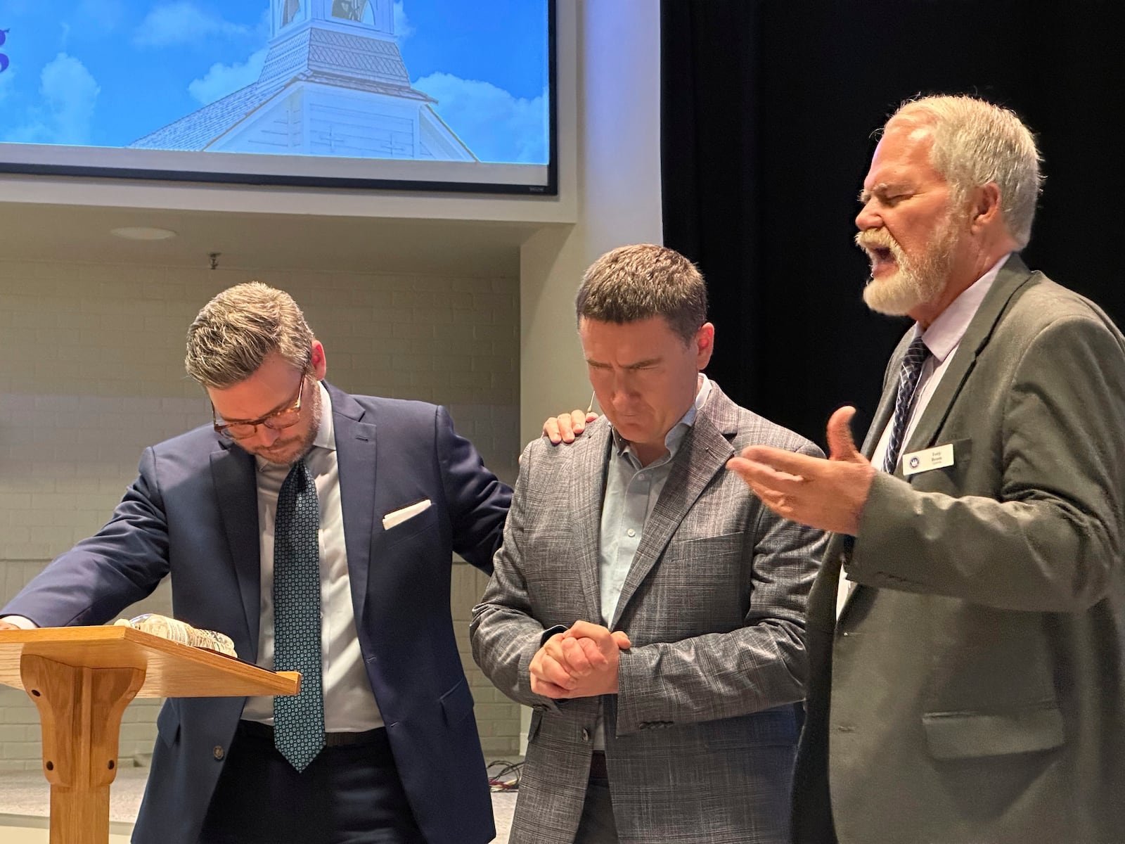 Tony Beam, right, then interim chair of the Ethics and Religious Liberty Commission of the Southern Baptist Convention, offers a prayer for Yaroslav Pyzh, president of the Ukrainian Baptist Theological Seminary, center, after Pyzh addressed commission trustees in Nashville, on Sept. 10, 2024. At left is Brent Leatherwood, president of the commission. (AP Photo/Peter Smith)