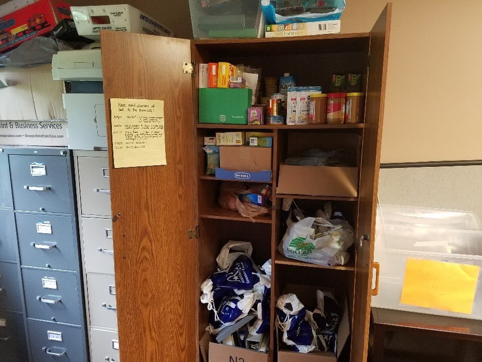 A cabinet containing food donations and bags at the Family Resource Center in Oxford.