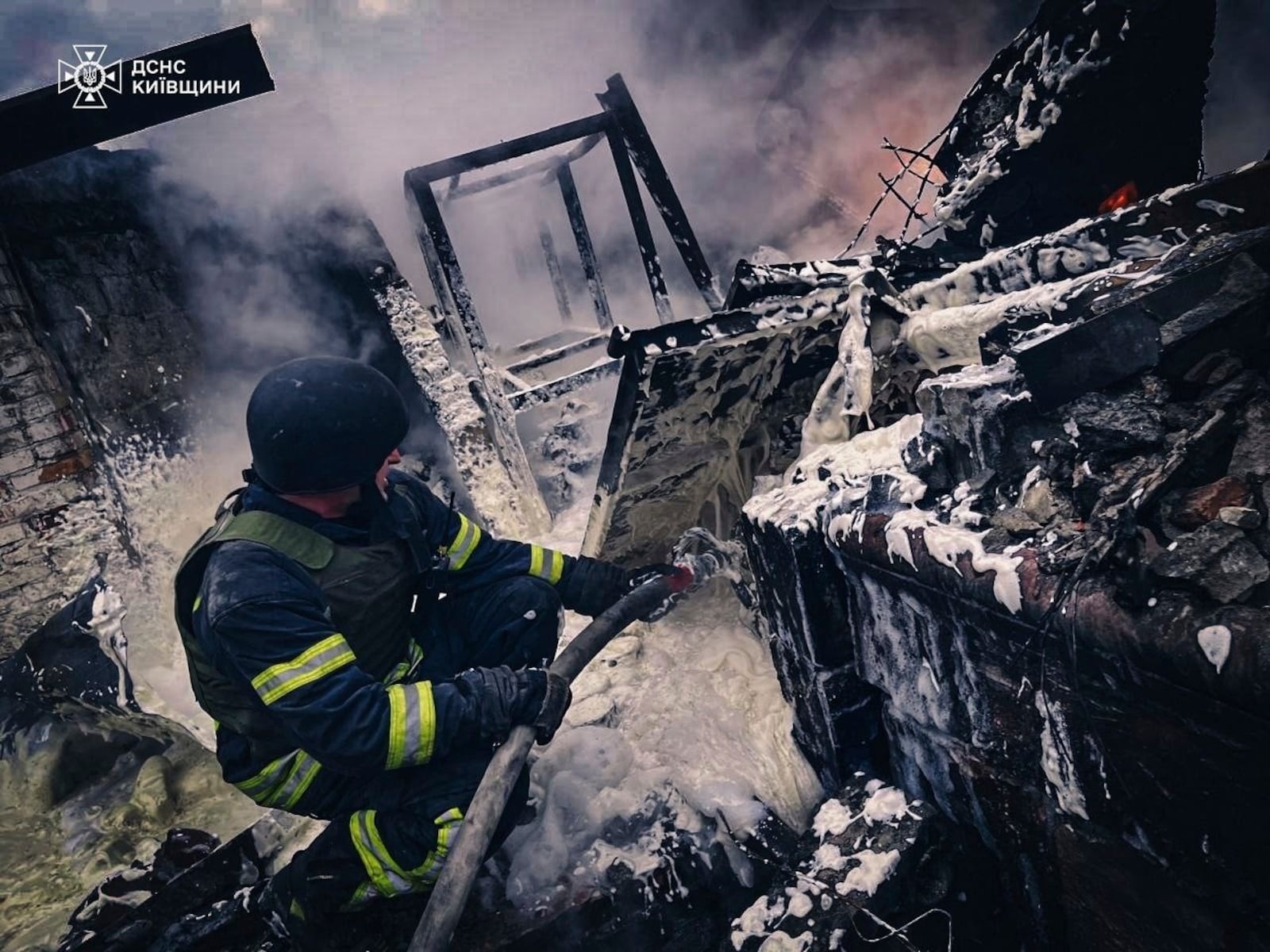 In this photo provided by the Ukrainian Emergency Service on Nov. 13, 2024, rescue workers extinguish a fire of a building destroyed by a Russian strike in Brovary, outside Kyiv, Ukraine. (Ukrainian Emergency Service via AP)