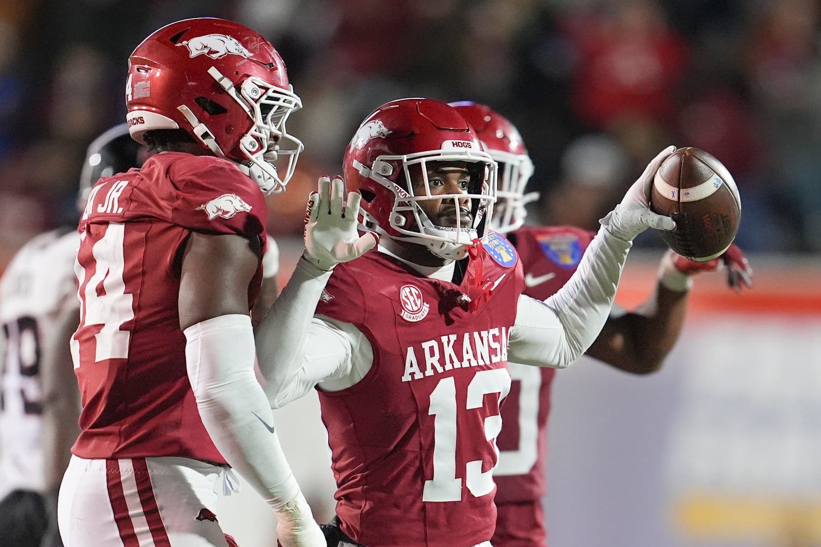 Arkansas defensive back Marquise Robinson (13) celebrates his interception during the second half of the Liberty Bowl NCAA college football game against Texas Tech, Friday, Dec. 27, 2024, in Memphis, Tenn. (AP Photo/George Walker IV)