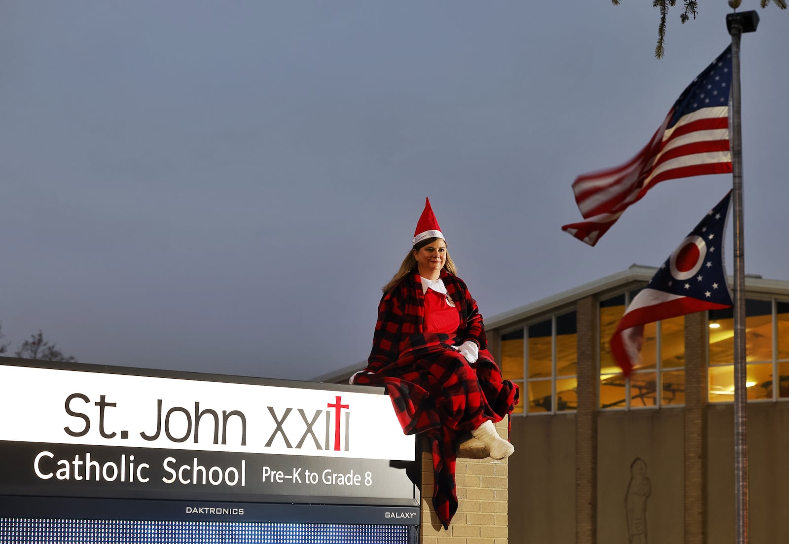 Dawn Pickerill, Principal of St. John XXIII Catholic School in Middletown, has been posing as "Elf on the Shelf" in different areas around the school in the mornings as students arrive. NICK GRAHAM/STAFF