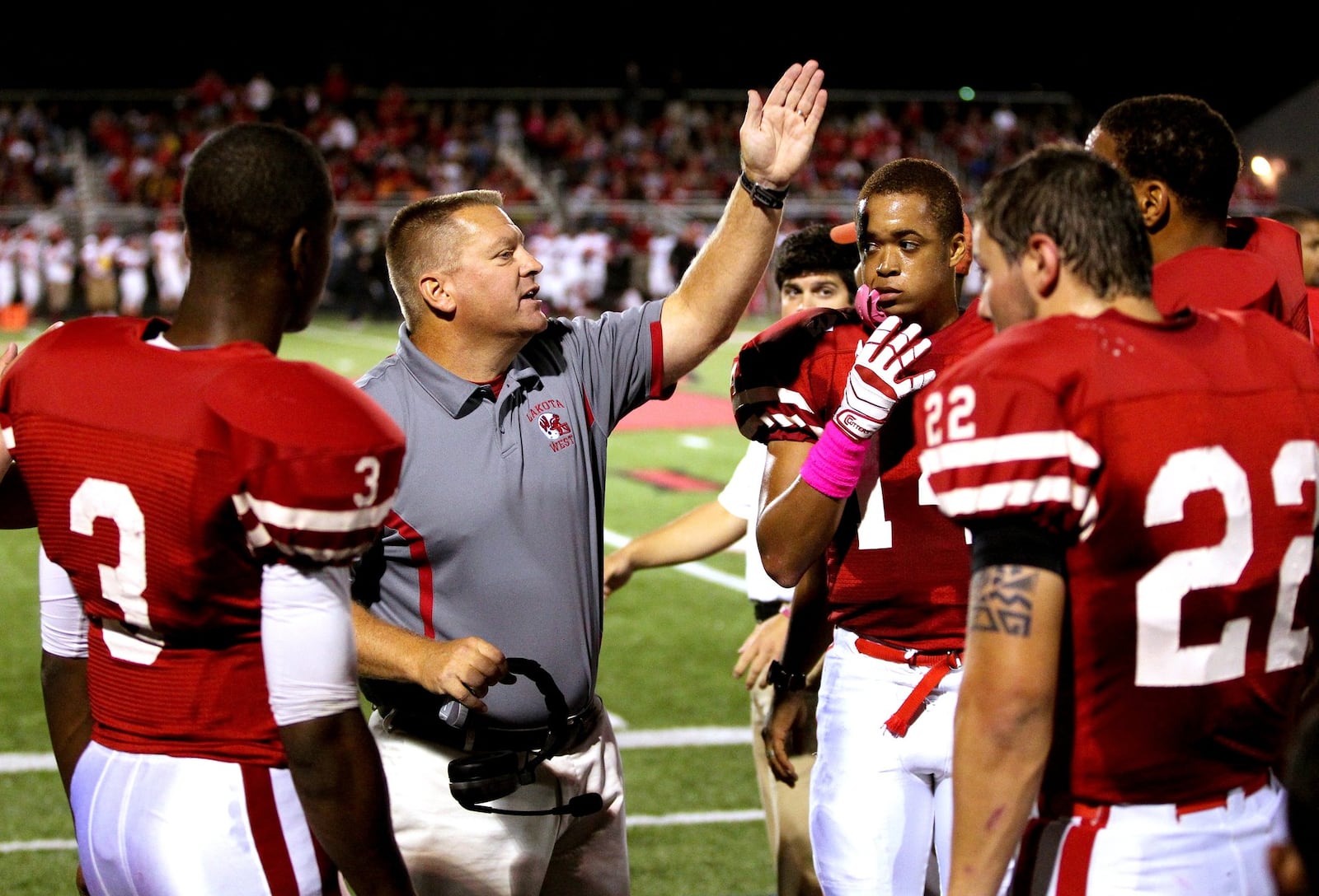 Lakota West coach Larry Cox talks with his team during a game against Fairfield at West on Oct. 11, 2013. The host Firebirds won 35-3. NICK DAGGY/STAFF