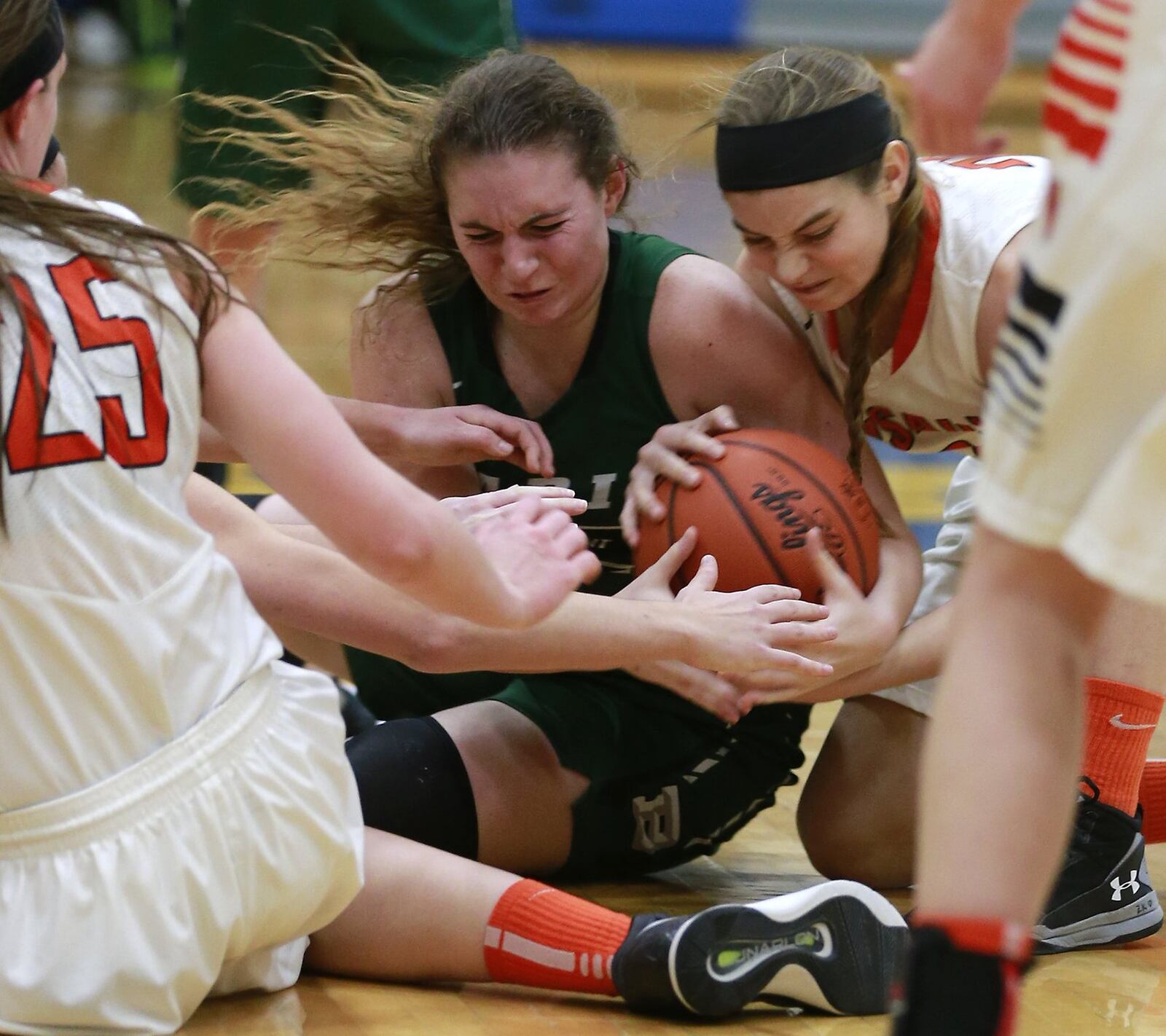 Badin’s Lauren Krause battles for possession of the ball with Versailles’ Clair Schmitmeyer during Wednesday night’s Division III regional semifinal at Springfield. BILL LACKEY/STAFF