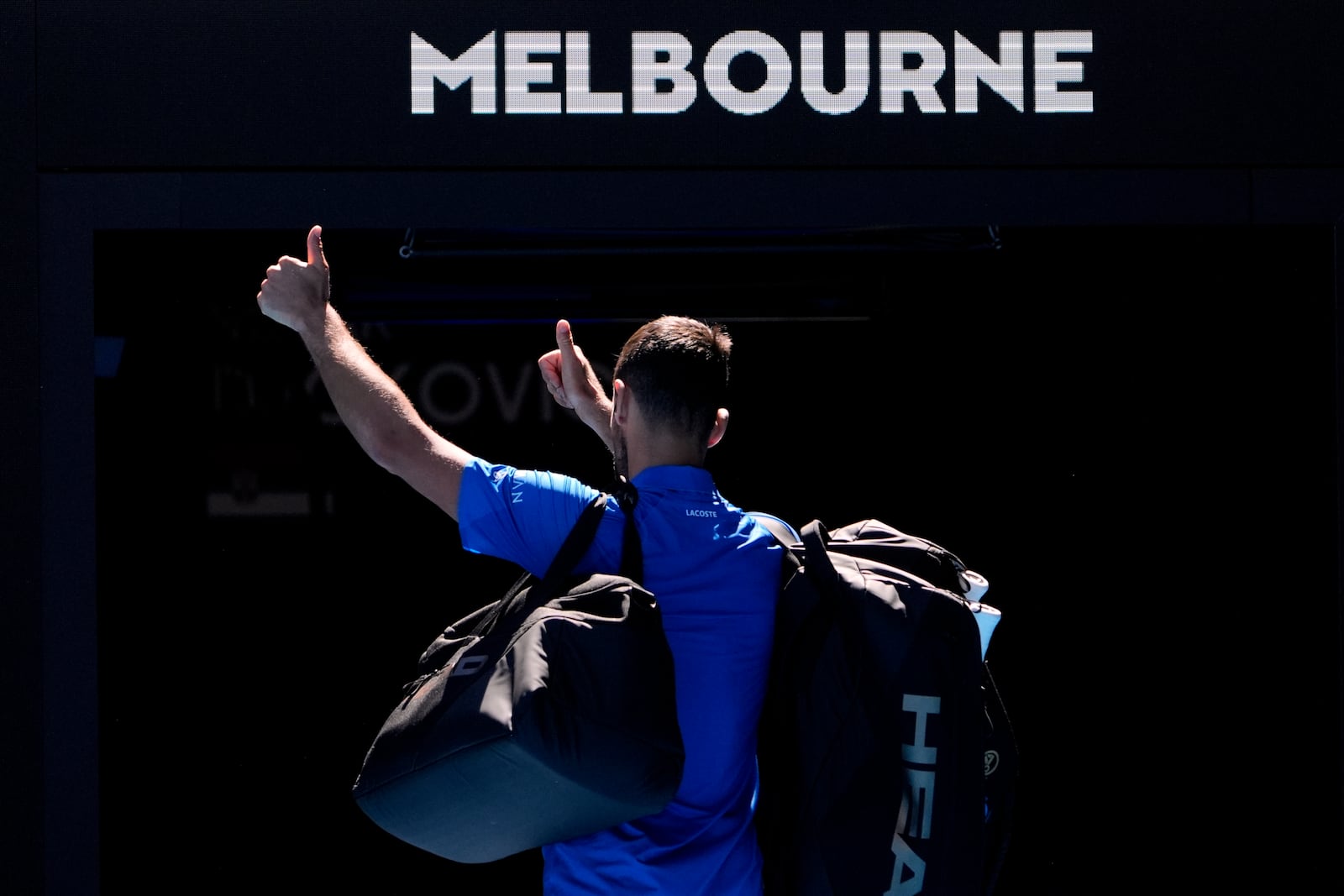 Novak Djokovic of Serbia gestures as he leaves Rod Laver Arena after retiring in his semifinal match against against Alexander Zverev of Germany at the Australian Open tennis championship in Melbourne, Australia, Friday, Jan. 24, 2025.(AP Photo/Asanka Brendon Ratnayake)