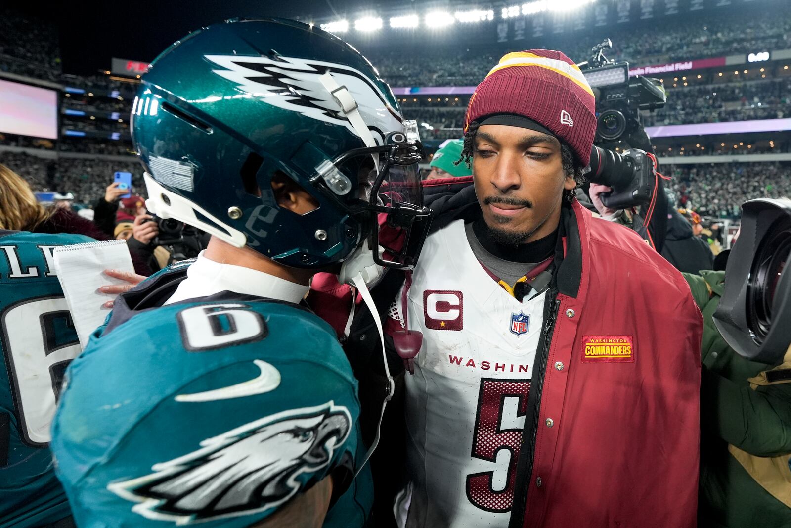 Washington Commanders quarterback Jayden Daniels greets Philadelphia Eagles wide receiver DeVonta Smith after their loss in the NFC Championship NFL football game, Sunday, Jan. 26, 2025, in Philadelphia. (AP Photo/Chris Szagola)