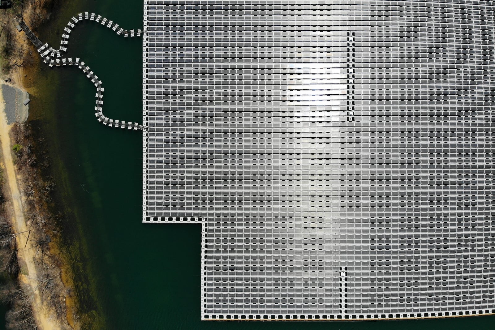 FILE - An array of solar panels float on top of a water storage pond in Sayreville, N.J., April 10, 2023. (AP Photo/Seth Wenig, File)