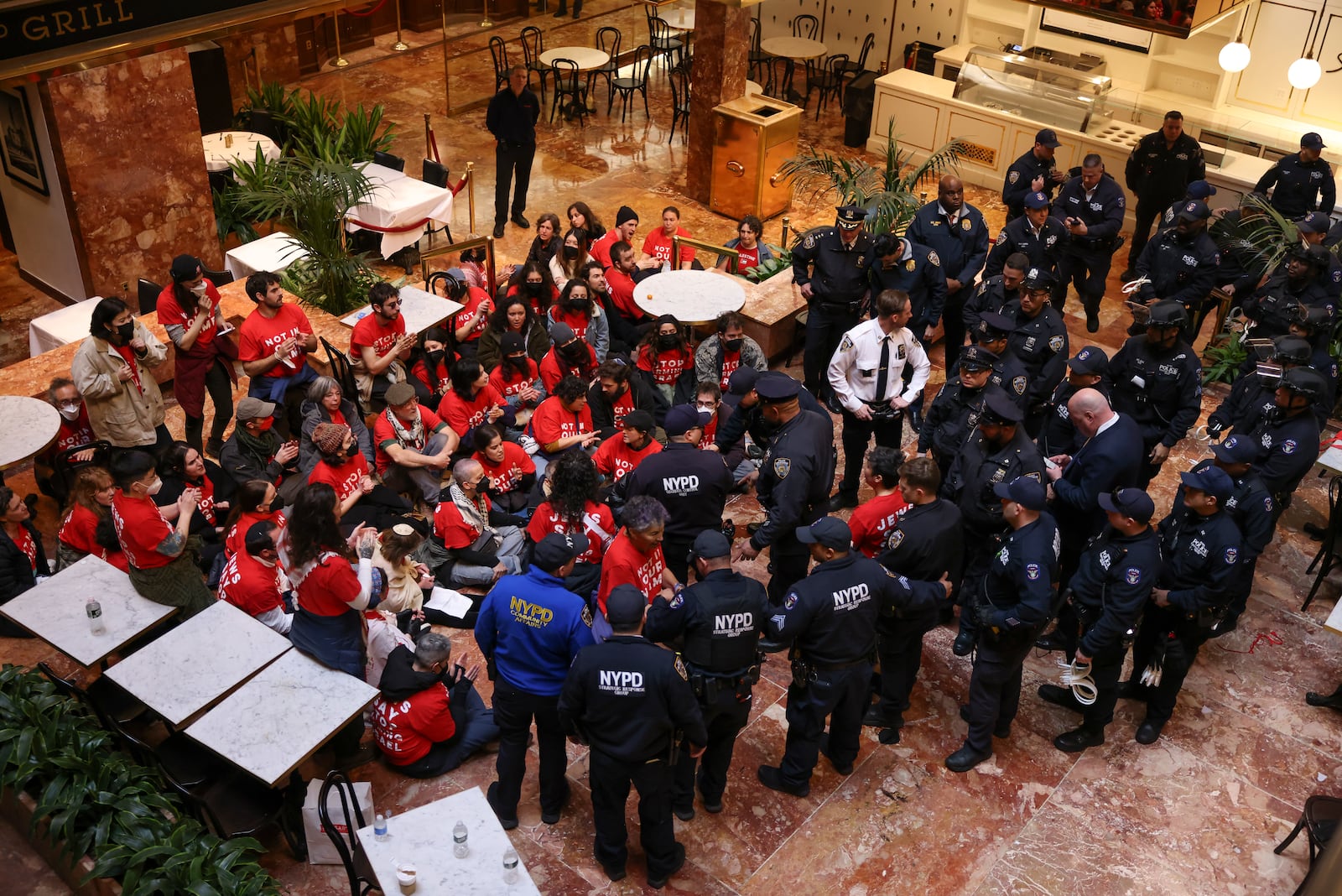 New York Police officers gather to arrest demonstrators from the group, Jewish Voice for Peace, who protested inside Trump Tower in support of Columbia graduate student Mahmoud Khalil, Thursday, March 13, 2025, in New York. (AP Photo/Yuki Iwamura)