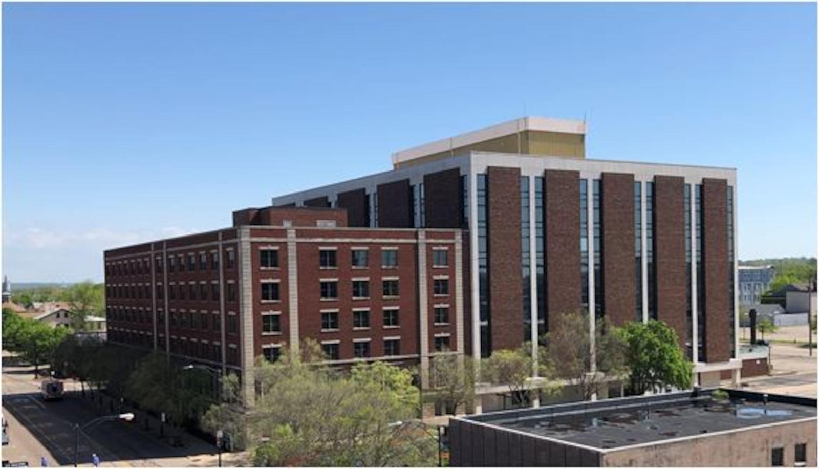 The Third + Dayton complex, part of which is shown here, used to be occupied by the Ohio Casualty insurance company, but now is finding new life with dozens of apartments and two companies moving in. This photo was taken from the top level of Hamilton's McDulin parking garage. MIKE RUTLEDGE/STAFF