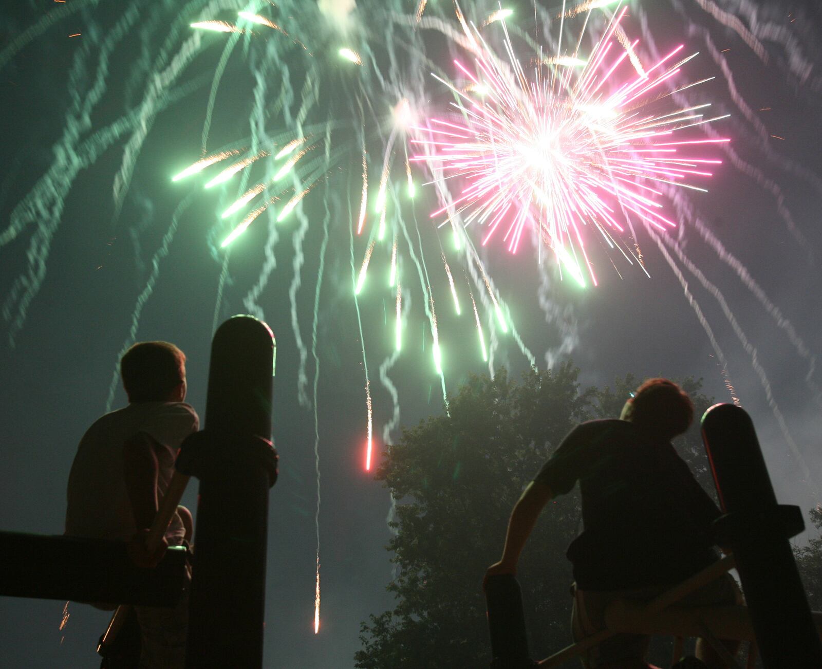 Kids watch from the playground as Rozzi's Famous Fireworks fill the sky at Harbin Park in Fairfield during the Red White and Kaboom celebration on July 3, 2009. GREG LYNCH/FILE