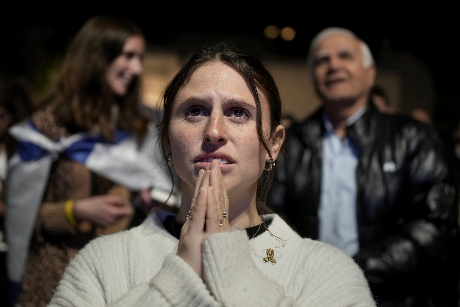 Relatives and friends of people killed and abducted by Hamas and taken into Gaza, react to the news of the hostages' release, as they gather in Tel Aviv, Israel on Sunday, Jan. 19, 2025. (AP Photo/Maya Alleruzzo)