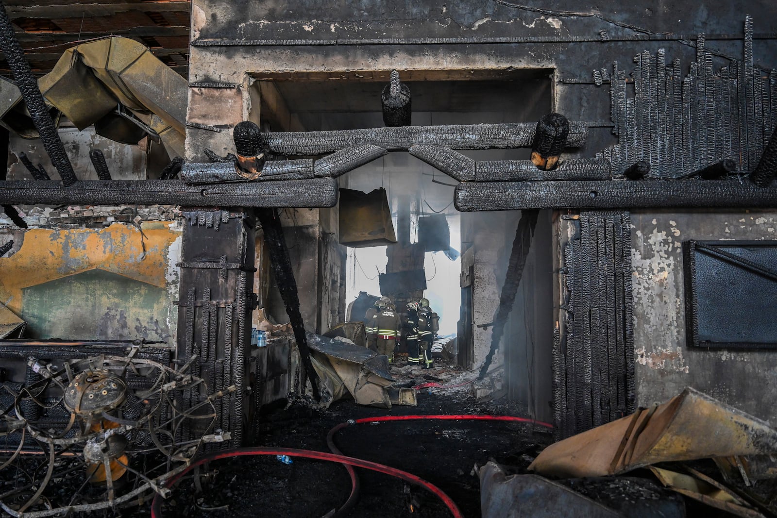 Firefighters work at the scene after a fire broke out at a hotel in the ski resort of Kartalkaya, located in Bolu province, northwest Turkey, on Tuesday, Jan. 21, 2025. (Mert Gokhan Koc/DIA Photo via AP)