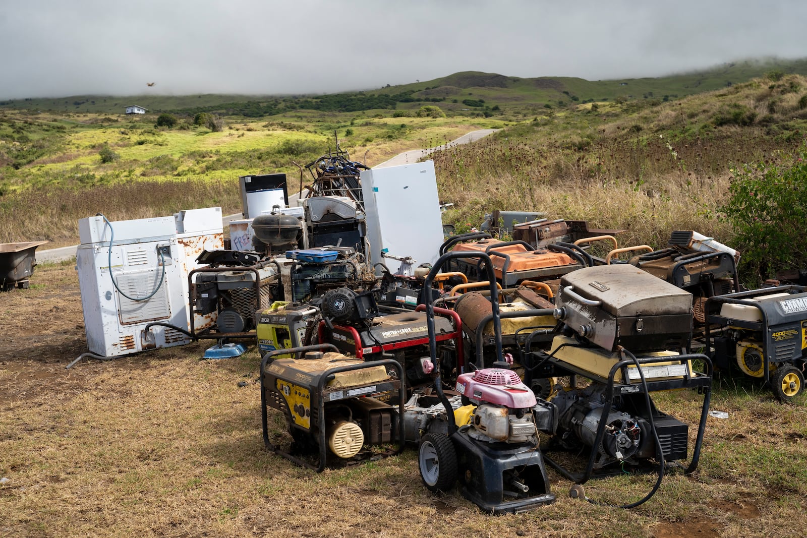 Unused refrigerators and generators are temporarily stored at Kahikinui homestead on Sunday, July 7, 2024, in Kahikinui, Hawaii. Residents were asked to remove unused items to reduce fire risks. (AP Photo/Mengshin Lin)