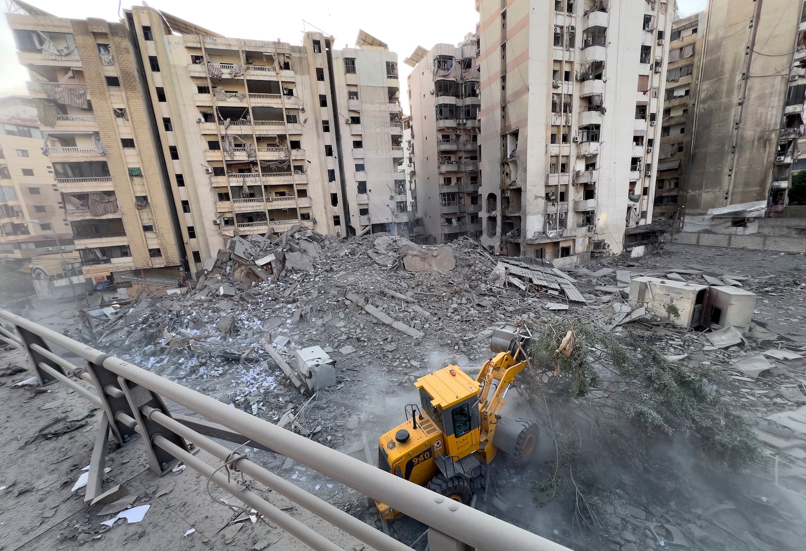 A municipality worker uses a bulldozer to remove the rubble of a destroyed building that was hit in an Israeli airstrike on Dahiyeh, in the southern suburb of Beirut, Lebanon, Friday, Nov. 1, 2024. (AP Photo/Hussein Malla)