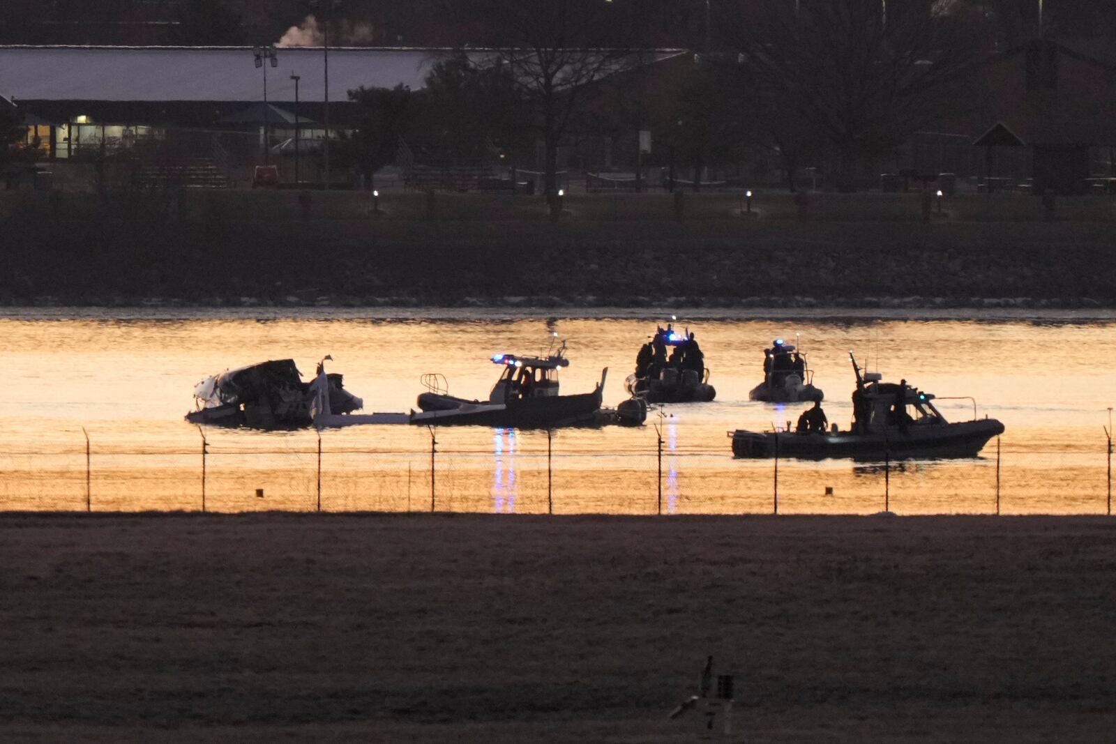 Search and rescue efforts are seen around a wreckage site in the Potomac River from Ronald Reagan Washington National Airport, early Thursday morning, Jan. 30, 2025, in Arlington, Va. (AP Photo/Mark Schiefelbein)