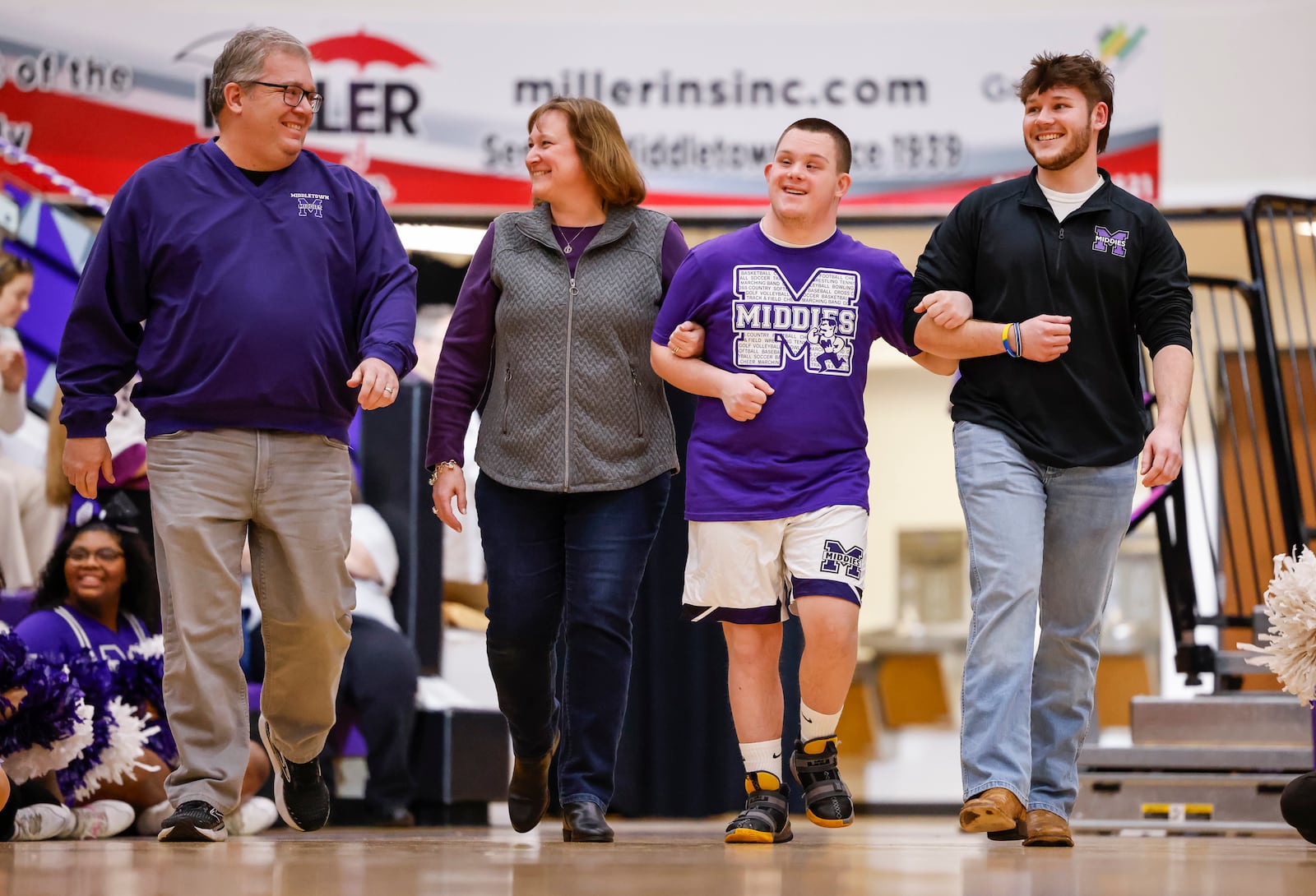 Luke Atkinson, a senior student manager at Middletown High School, was introduced along with other seniors before the game Tuesday night, started the basketball game against Mason and scored a basket. He was accompanied on the court by his parents, Mark and Jennifer, and brother, Jake. NICK GRAHAM/STAFF