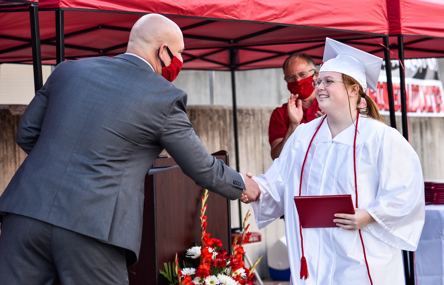 Madison High School drive-thru graduation ceremony at Land of Illusion