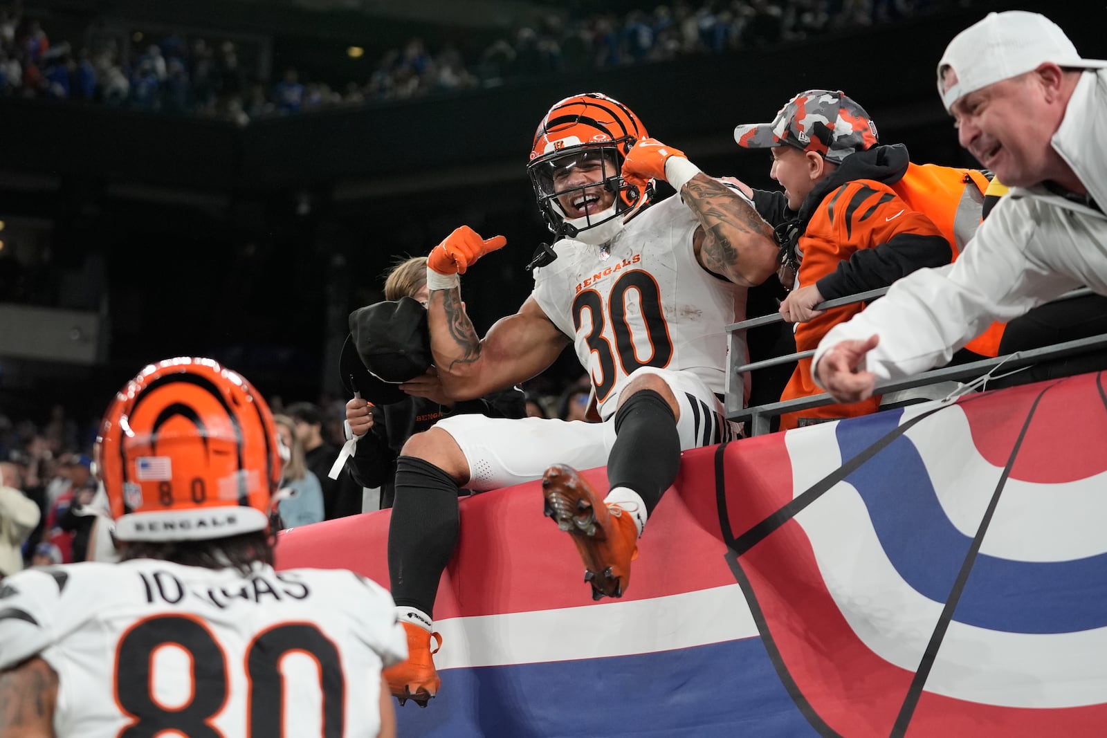 Cincinnati Bengals running back Chase Brown (30) celebrates with fans after scoring a touchdown in the second half of an NFL football game against the New York Giants, Sunday, Oct. 13, 2024, in East Rutherford, N.J. (AP Photo/Frank Franklin II)