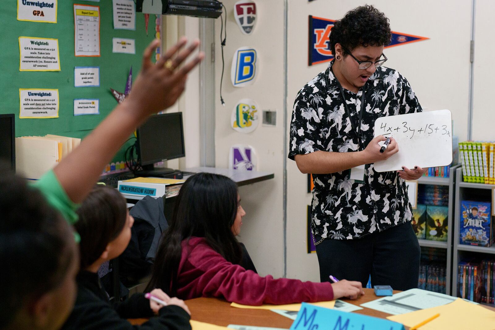 A tutor helps students at Benjamin O. Davis Middle School in Compton, Calif., Thursday, Feb. 6, 2025. (AP Photo/Eric Thayer)