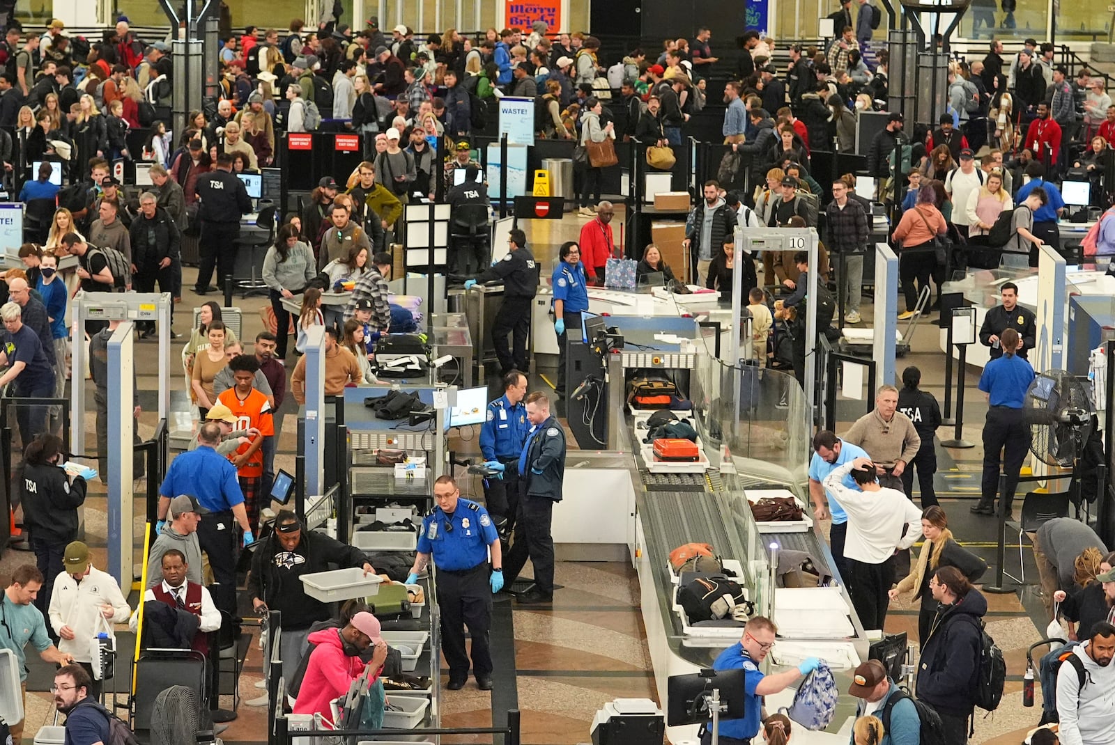 Travelers wade through the south security checkpoint in Denver International Airport Thursday, Dec. 19, 2024, in Denver. (AP Photo/David Zalubowski)