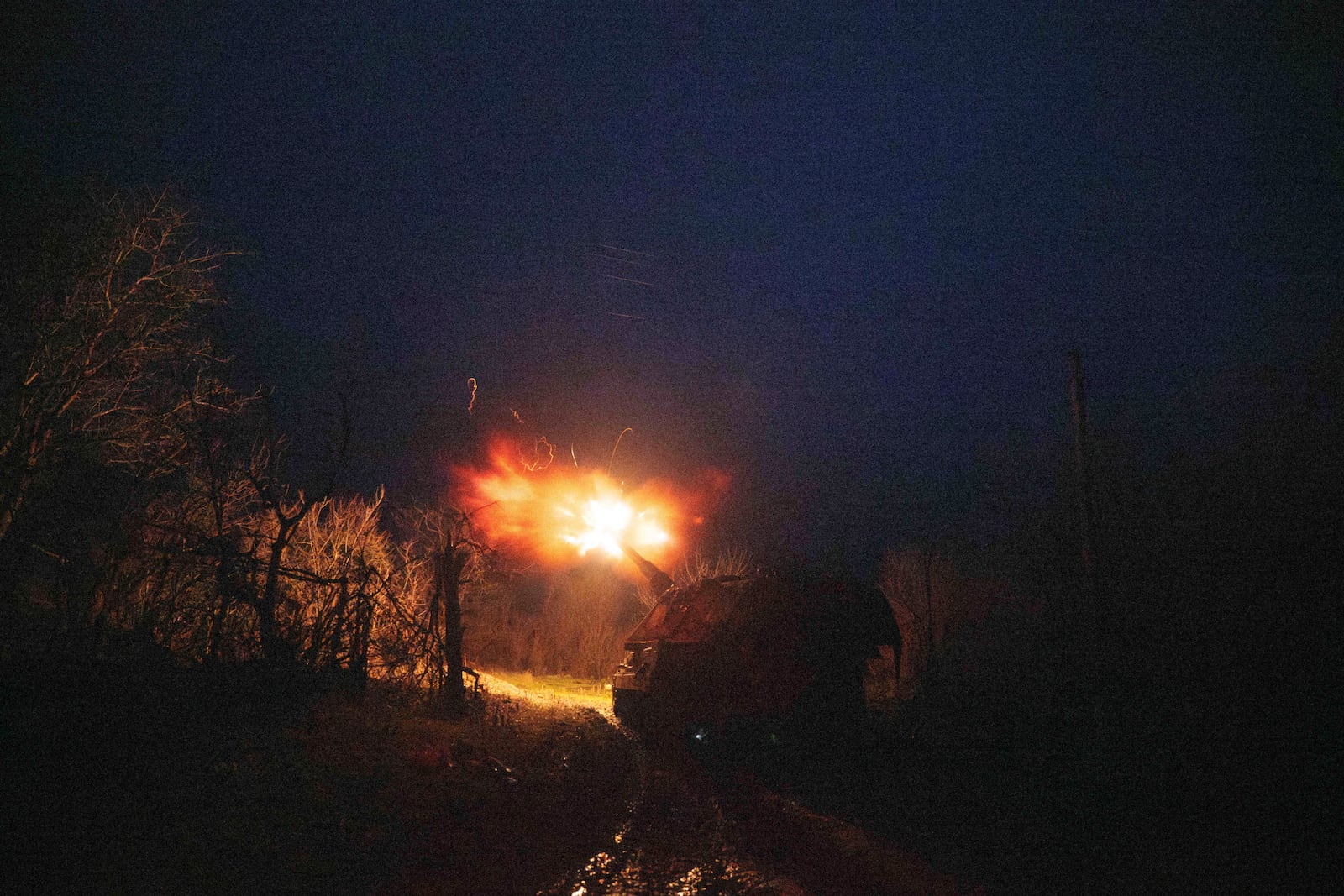 A Ukrainian AS-90 self-propelled artillery vehicle fires towards Russian positions at the frontline on Pokrovsk direction, Donetsk region, Ukraine, Wednesday, Dec. 23, 2024. (AP Photo/Evgeniy Maloletka)