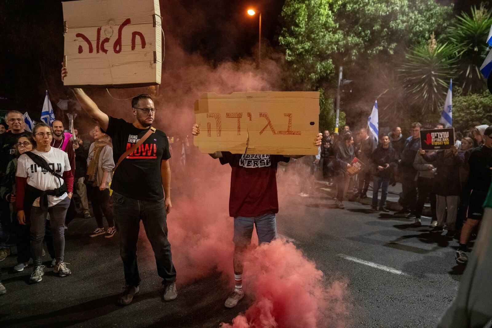 People protest against Prime Minister Benjamin Netanyahu near his residence in Jerusalem after he has dismissed his defense minister Yoav Gallant in a surprise announcement, Tuesday, Nov. 5, 2024. (AP Photo/Ohad Zwigenberg)