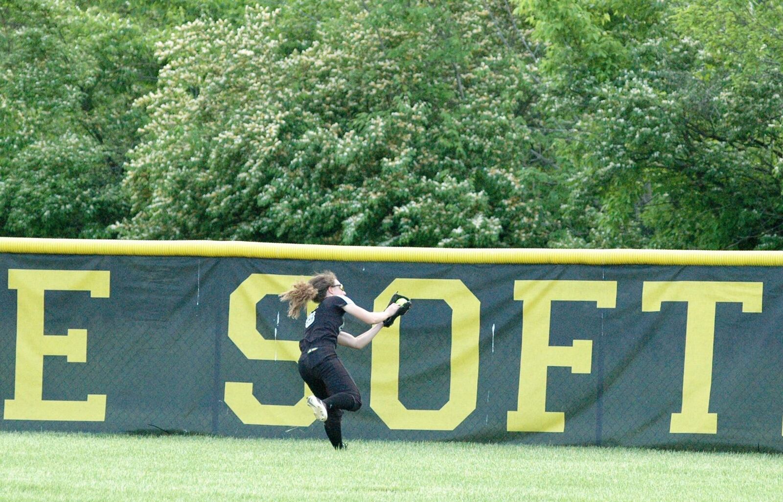 Lakota East center fielder Kylee West makes a running catch in the fifth inning Friday during a 3-0 win over Lebanon in a Division I district softball championship game at Centerville. RICK CASSANO/STAFF