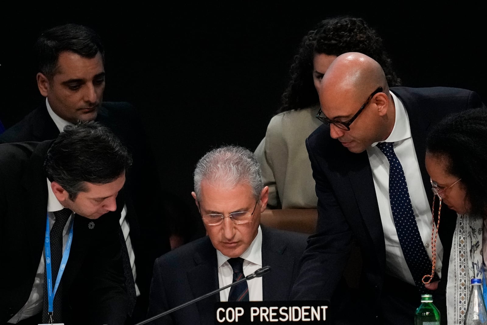 Yalchin Rafiyev, Azerbaijan's COP29 lead negotiator, left, Mukhtar Babayev, COP29 President, center, and Simon Stiell, United Nations climate chief, talk ahead of a plenary session at the COP29 U.N. Climate Summit, Sunday, Nov. 24, 2024, in Baku, Azerbaijan. (AP Photo/Rafiq Maqbool)