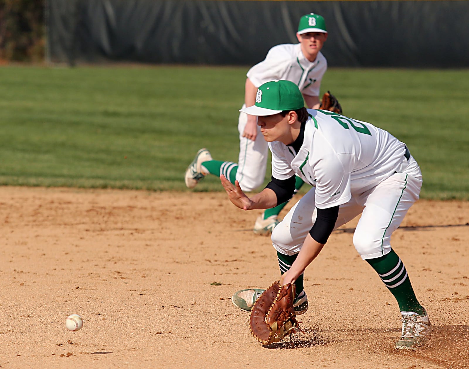 Badin first baseman Devon Valentino fields a Defiance ground ball Wednesday at Alumni Field in Hamilton. CONTRIBUTED PHOTO BY E.L. HUBBARD