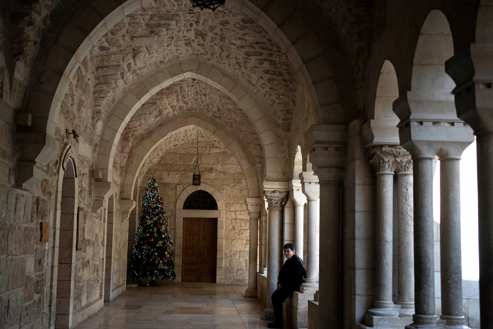 A lone Christmas tree is seen in the Church of the Nativity complex, where Christians believe Jesus Christ was born, ahead of Orthodox Christmas Eve mass in the West Bank city of Bethlehem, Monday, Jan. 6, 2025. (AP Photo/Maya Alleruzzo)